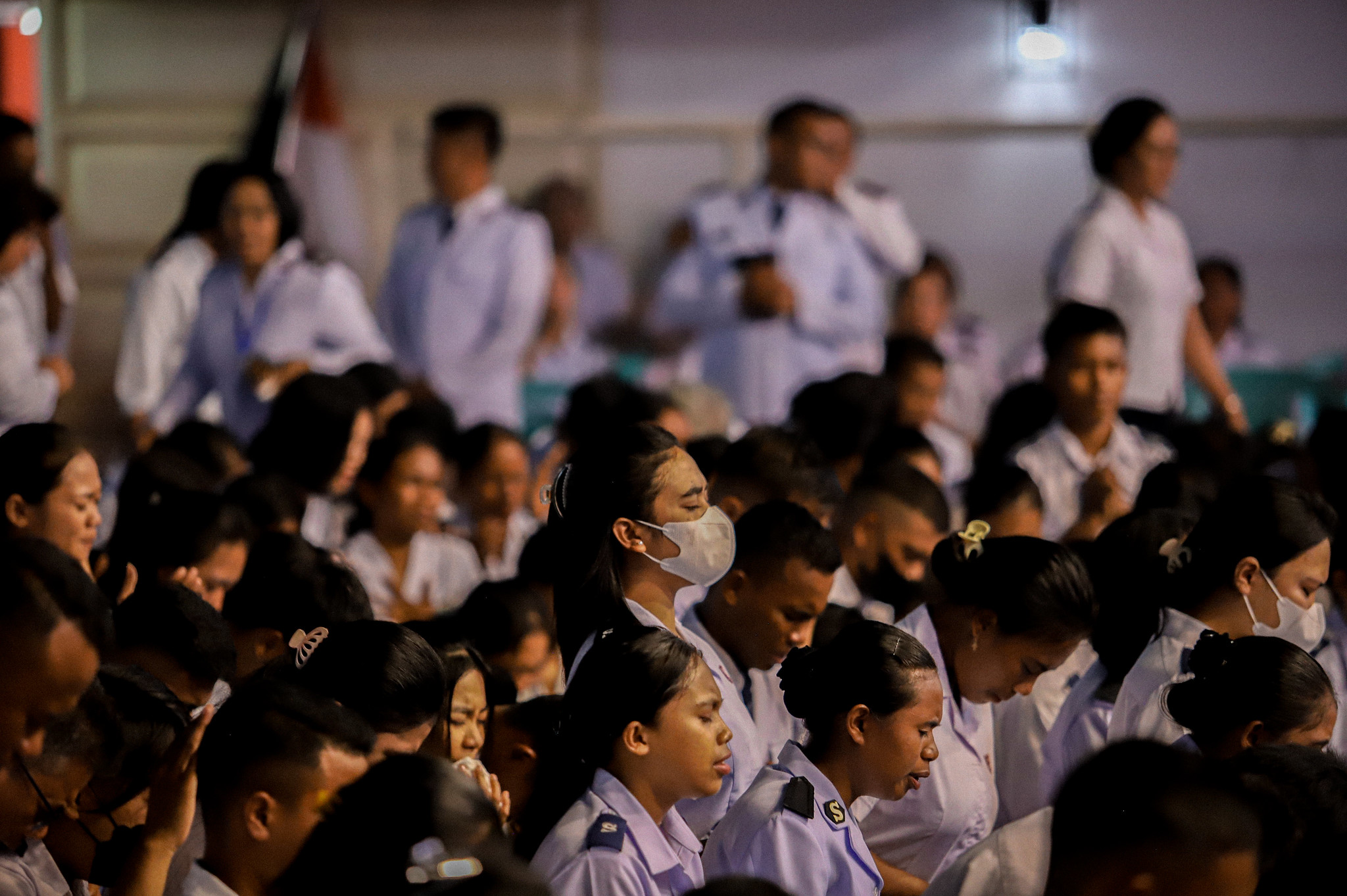 A group of Salvationists bow their heads in prayer