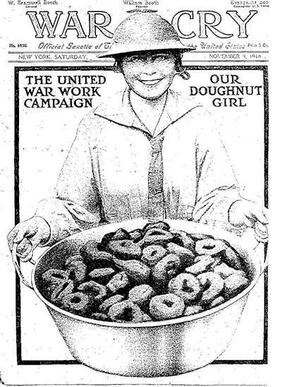 Magazine cover with an illustration of a woman in a tin helmet holding a large pan filled with doughnuts