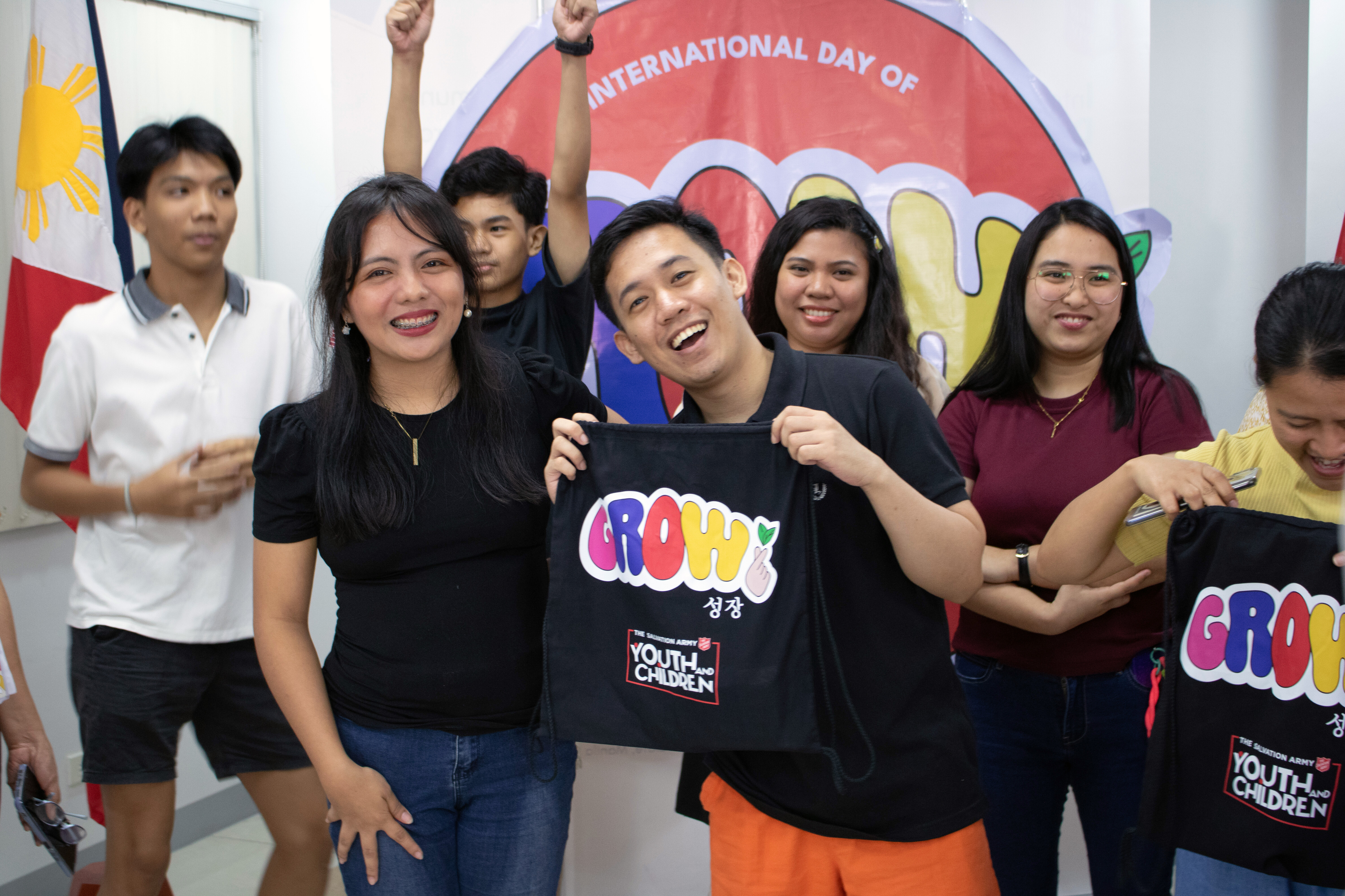 A group of young people smile at the camera