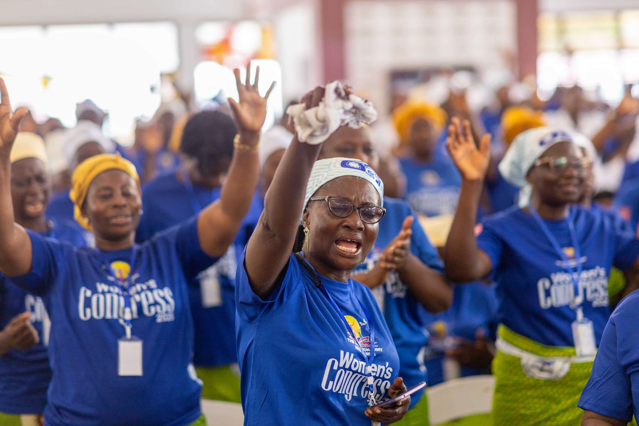 Women raise their hands in worship