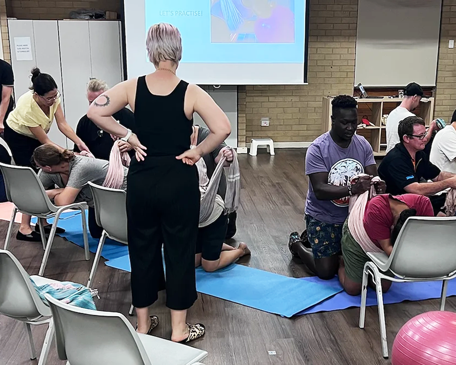 A number of couples take part in a pregnancy class