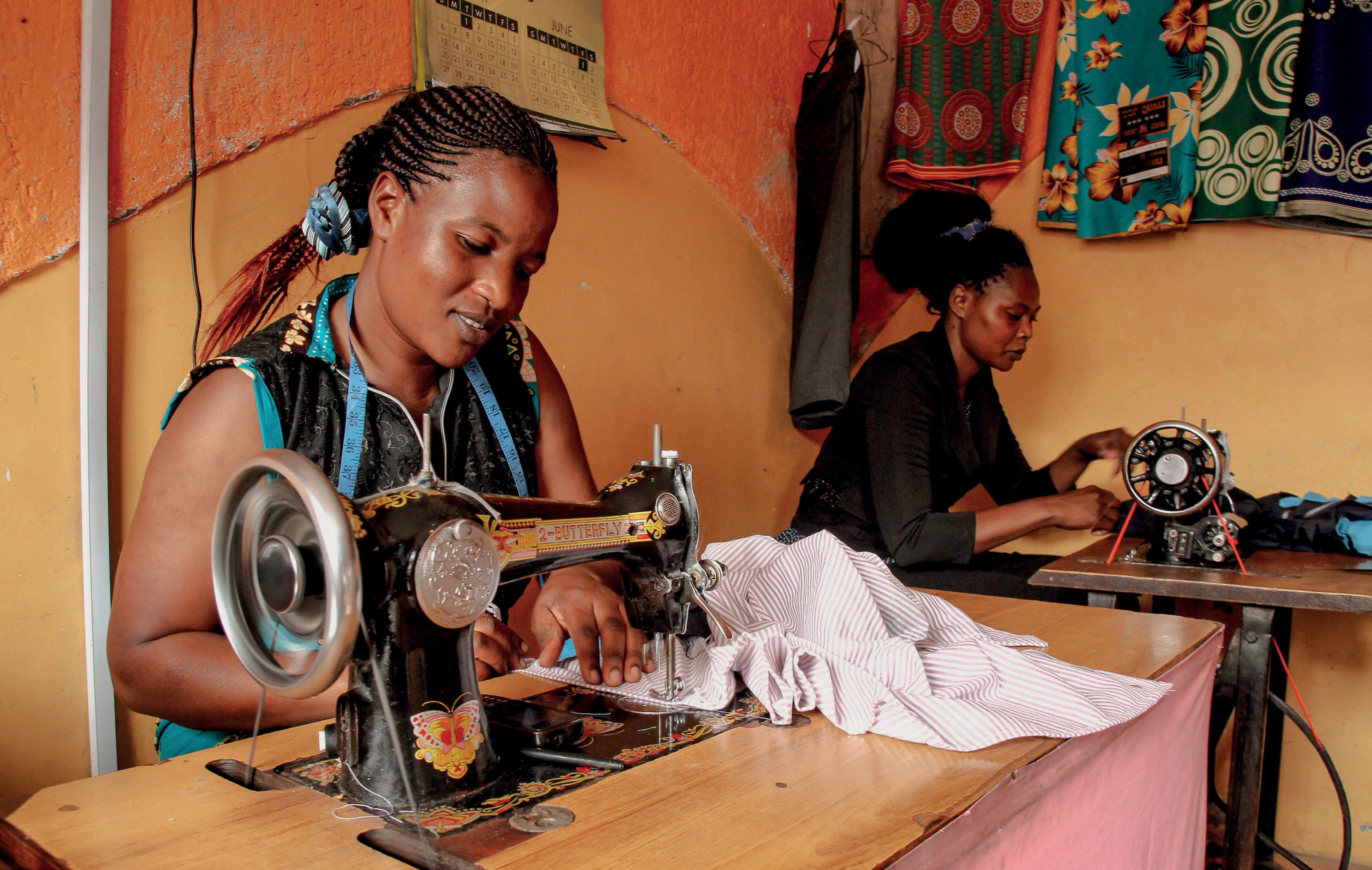 Two women work at sewing machines
