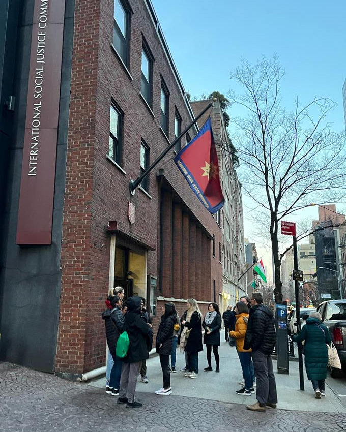 A group stand outside the ISJC building in New York