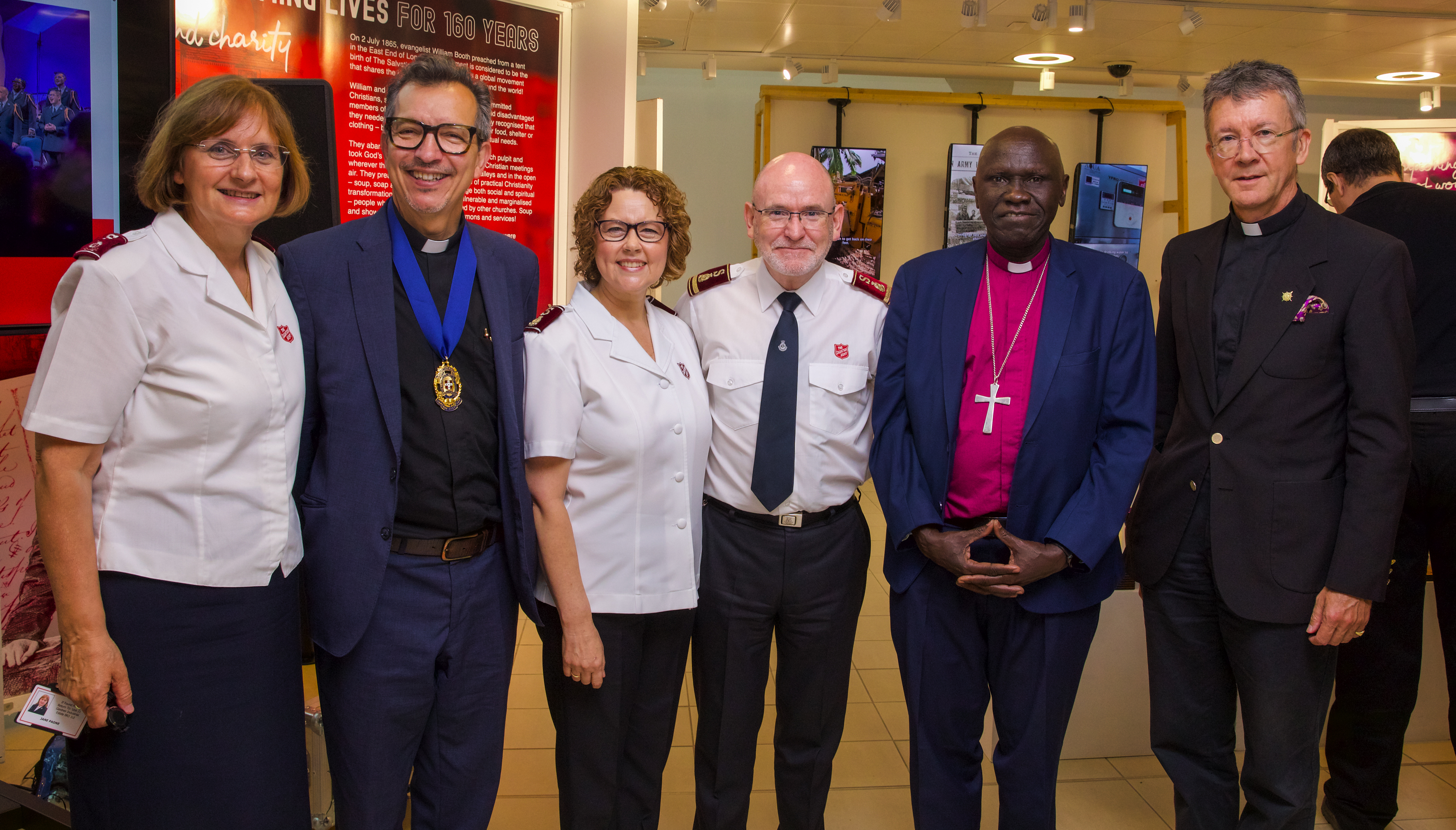 Commissioner Jane Paone, Revd Dr Leão Neto, Commissioner Bronwyn Buckingham, General Lyndon Buckingham, Bishop Anthony Poggo and Revd Neil Vigers in front of Gallery 101