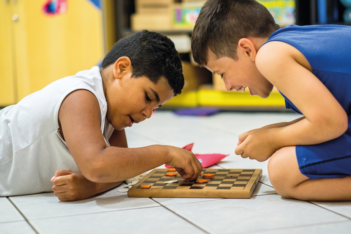 Two boys play a board game
