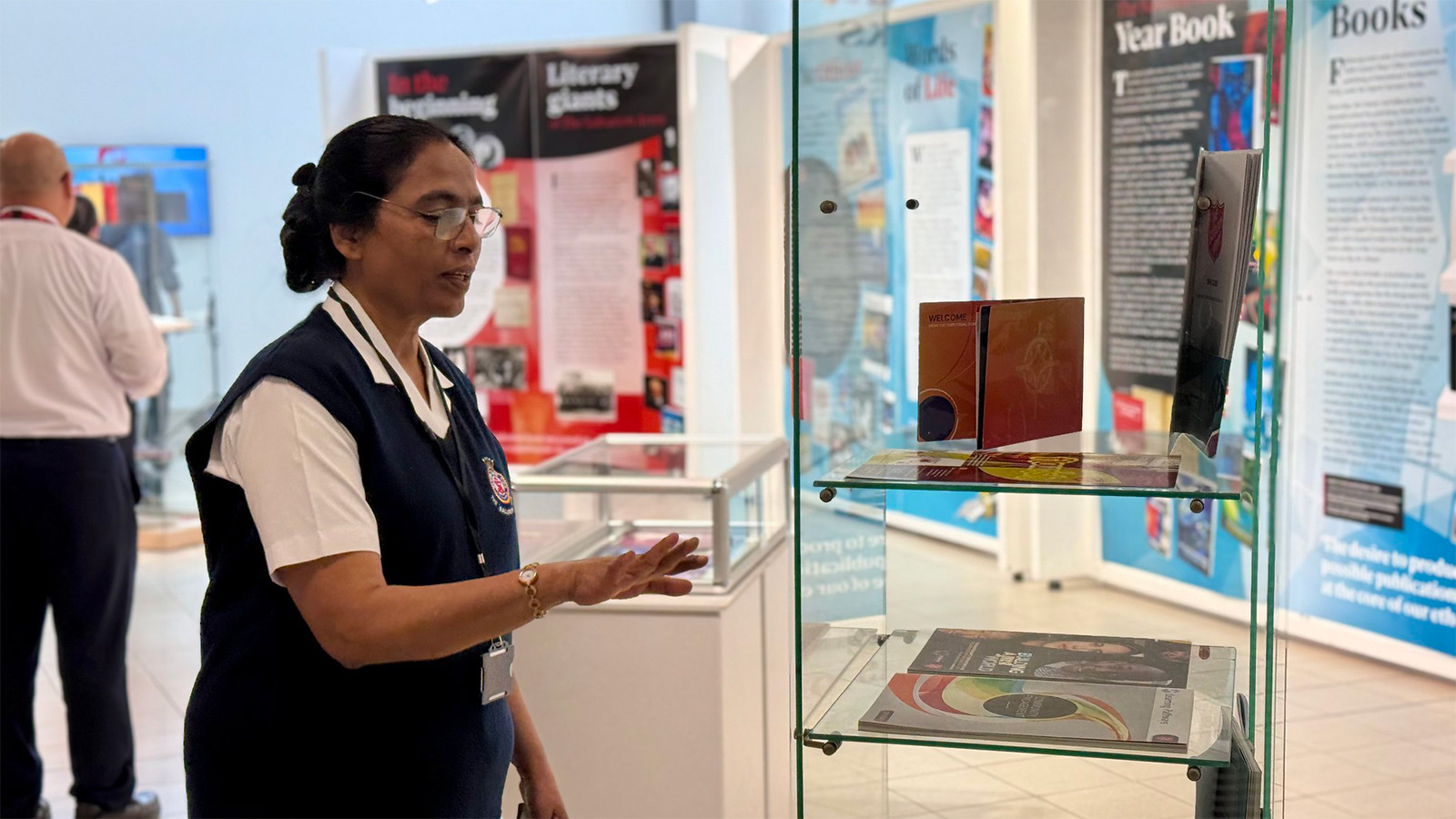 A woman in Salvation Army uniform looks at the exhibition