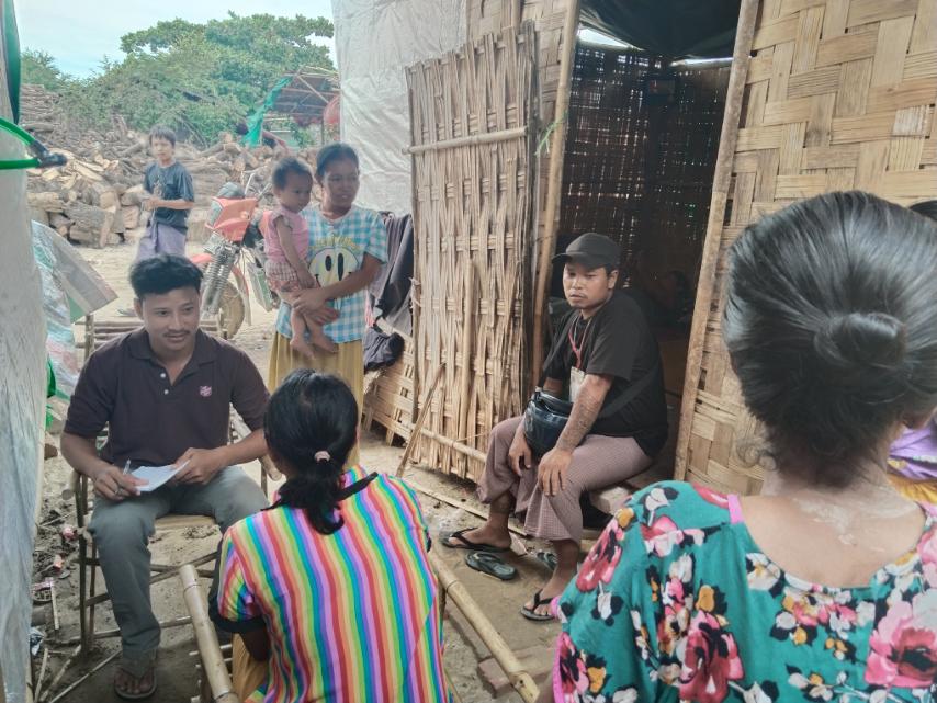 A Salvation Army team member speaks to local people in Myanmar