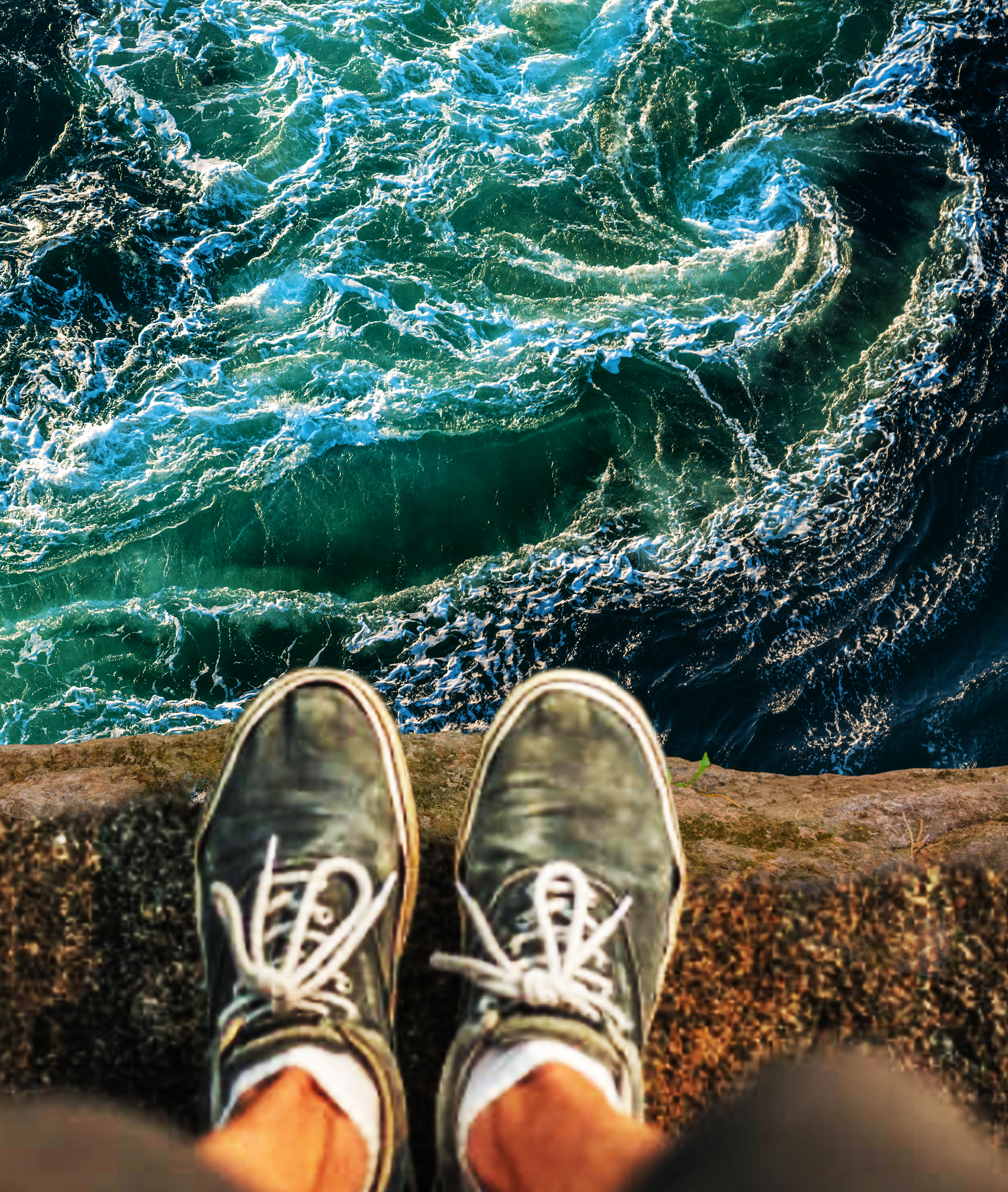 Standing at the edge of a cliff