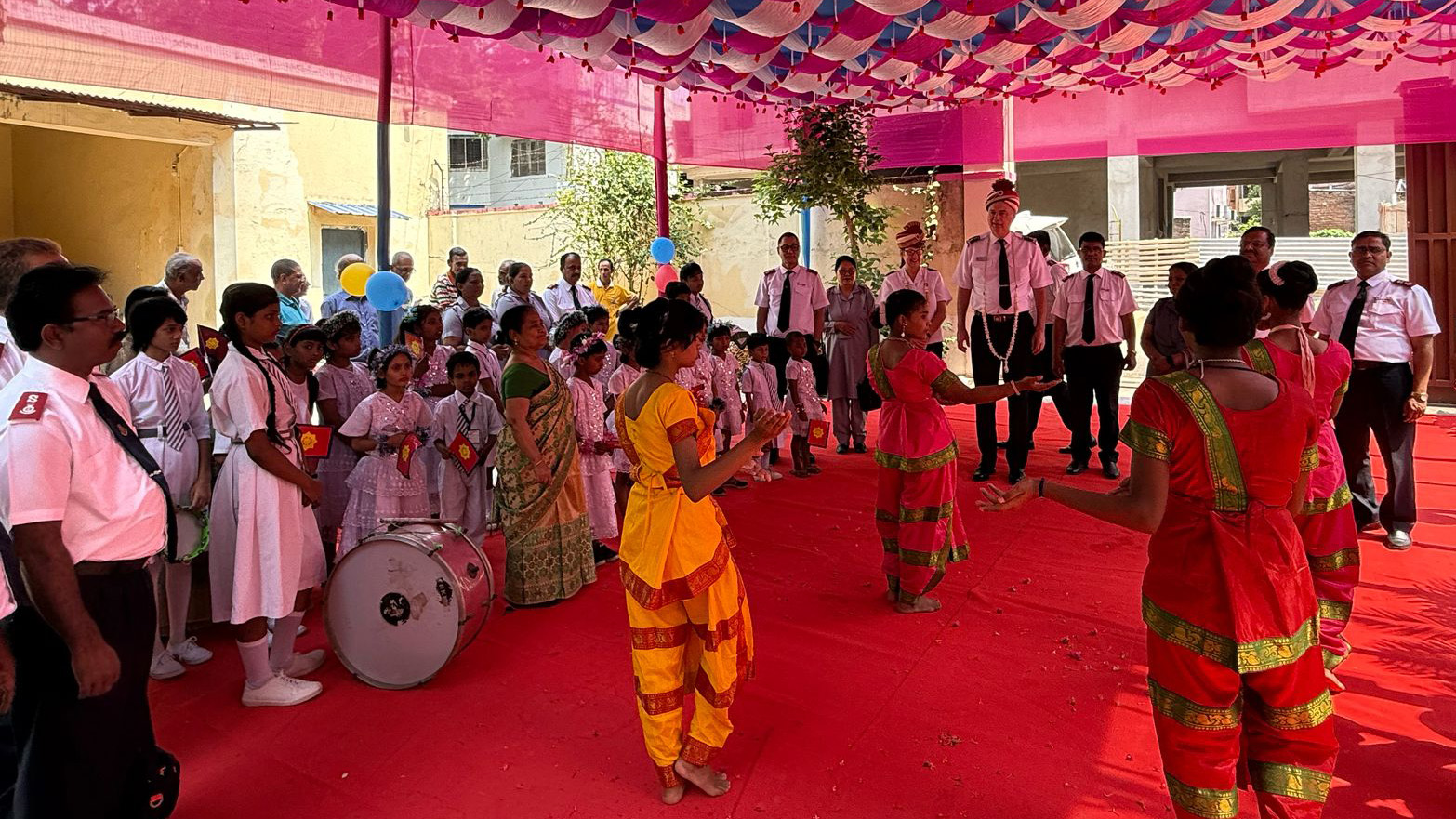Commissioners Hill are welcomed by a crowd, music and dancers