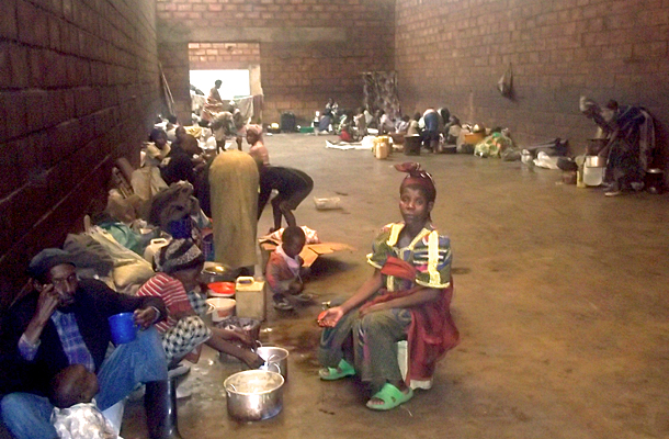 Families at Nkamira Transit Camp, Rwanda, seek shelter