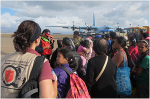 Damaris Frick with queues of people waiting to leave on emergency flights from Tacloban Airport