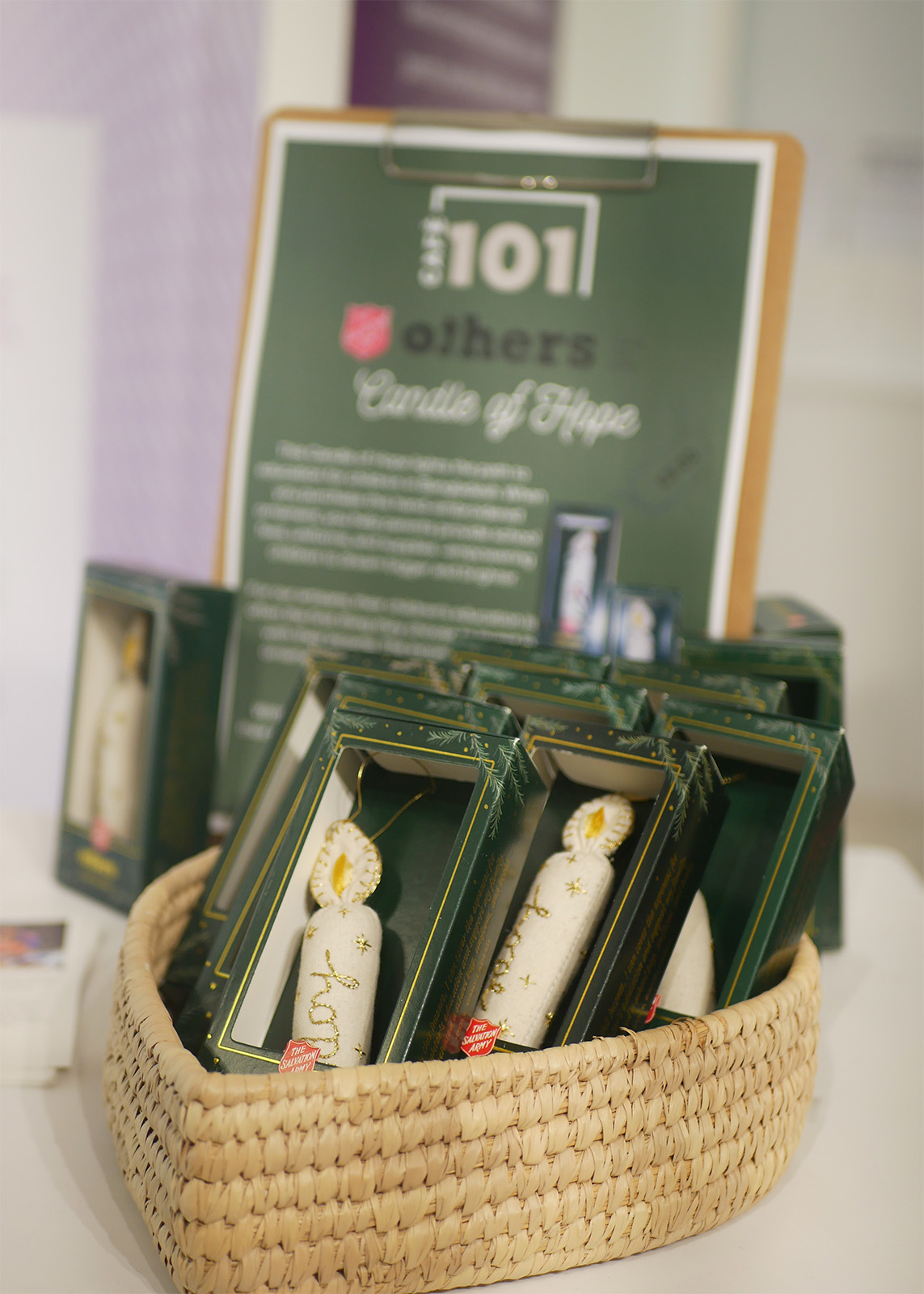 A selection of Candle of Hope ornaments in a woven basket