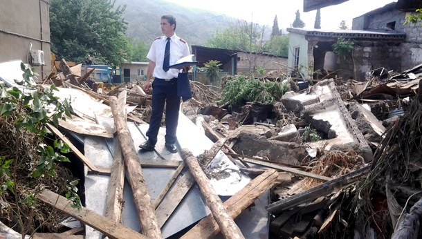 Captain David Kotrikadze (Finance and Property Officer, Georgia Region) looks at damaged property in Tbilisi