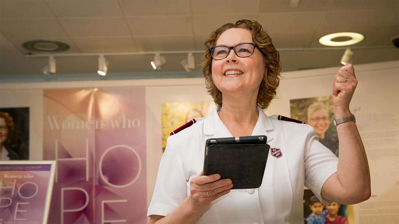 Commissioner Bronwyn Buckingham stands in front of the Women Who Hope exhibition