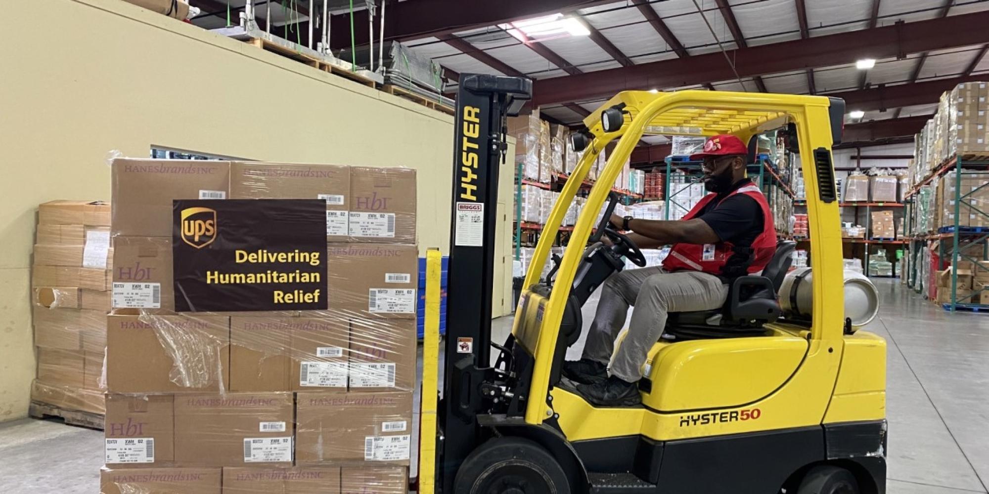 Fork-lift truck loading Salvation Army emergency supplies