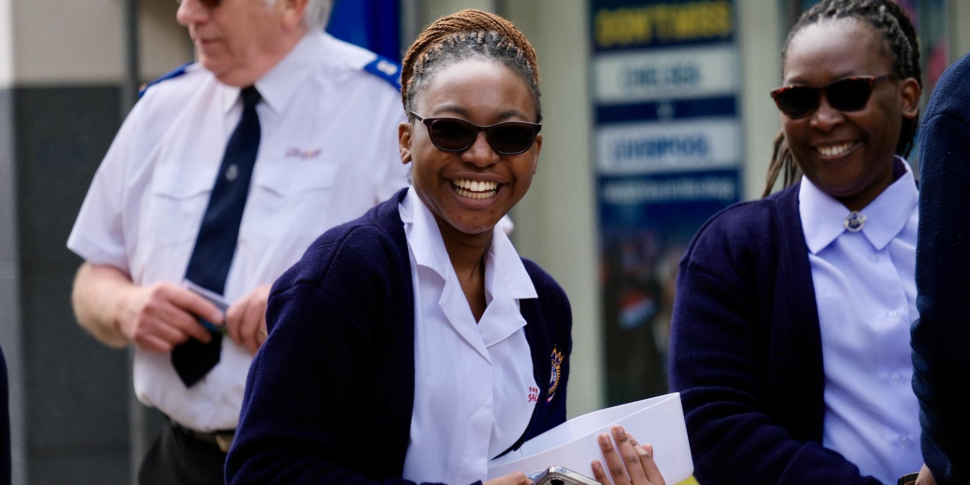 Women in Salvation Army uniform smile at the camera