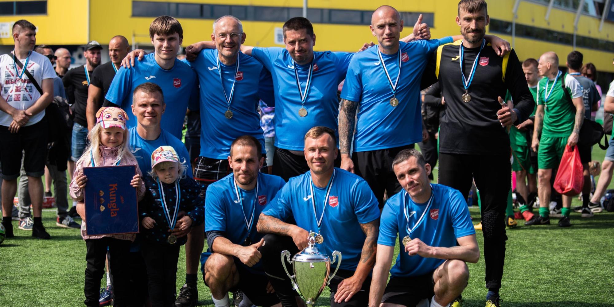 A football team with medals and Salvation Army shirts