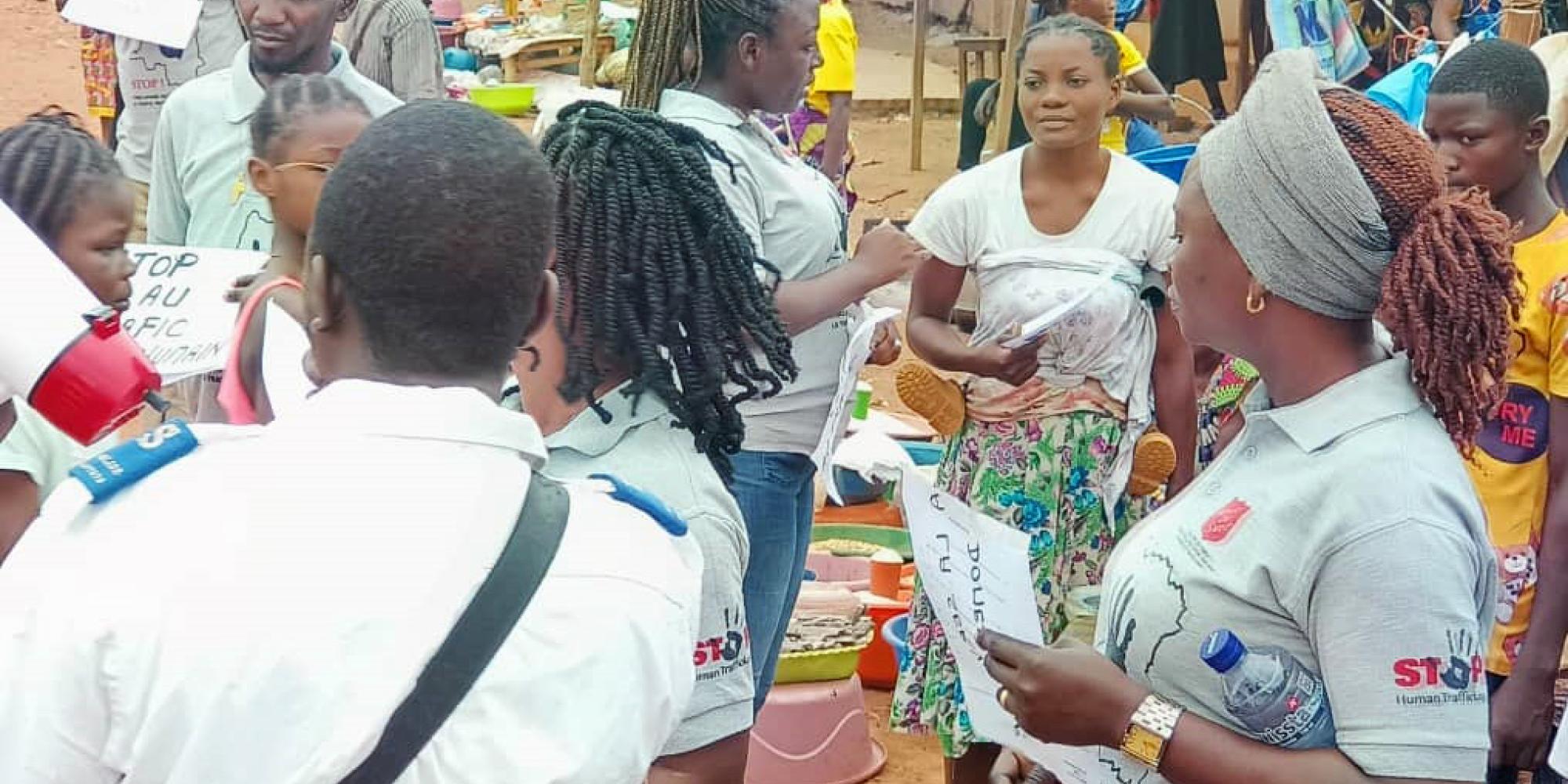 Women in Salvation Army t-shirts speak to people on the street