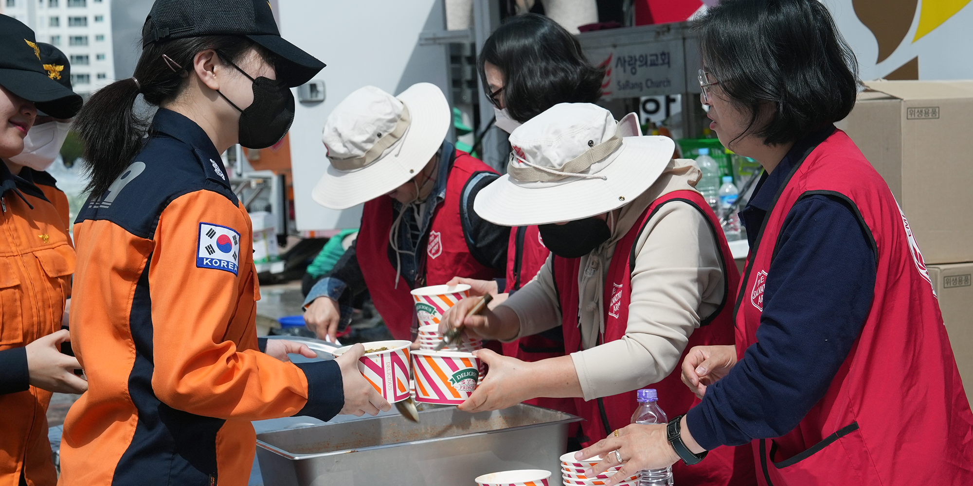 People in Salvation Army jackets hand out food