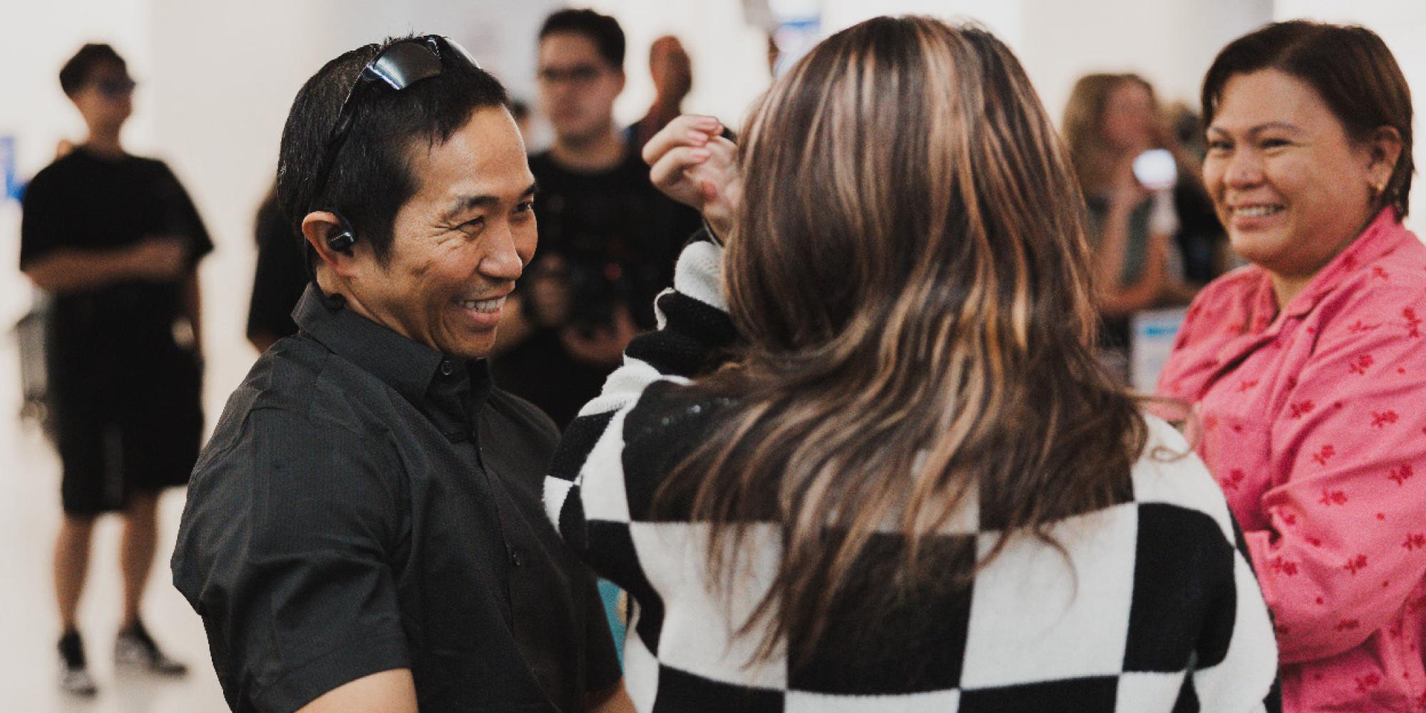 A father smiles as he talks to his family