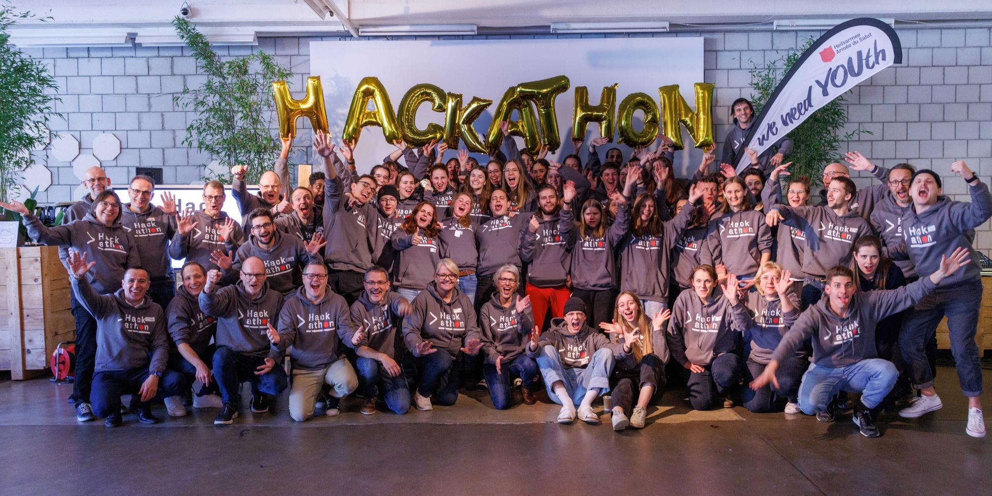 A group of people in Salvation Army hoodies pose for the camera