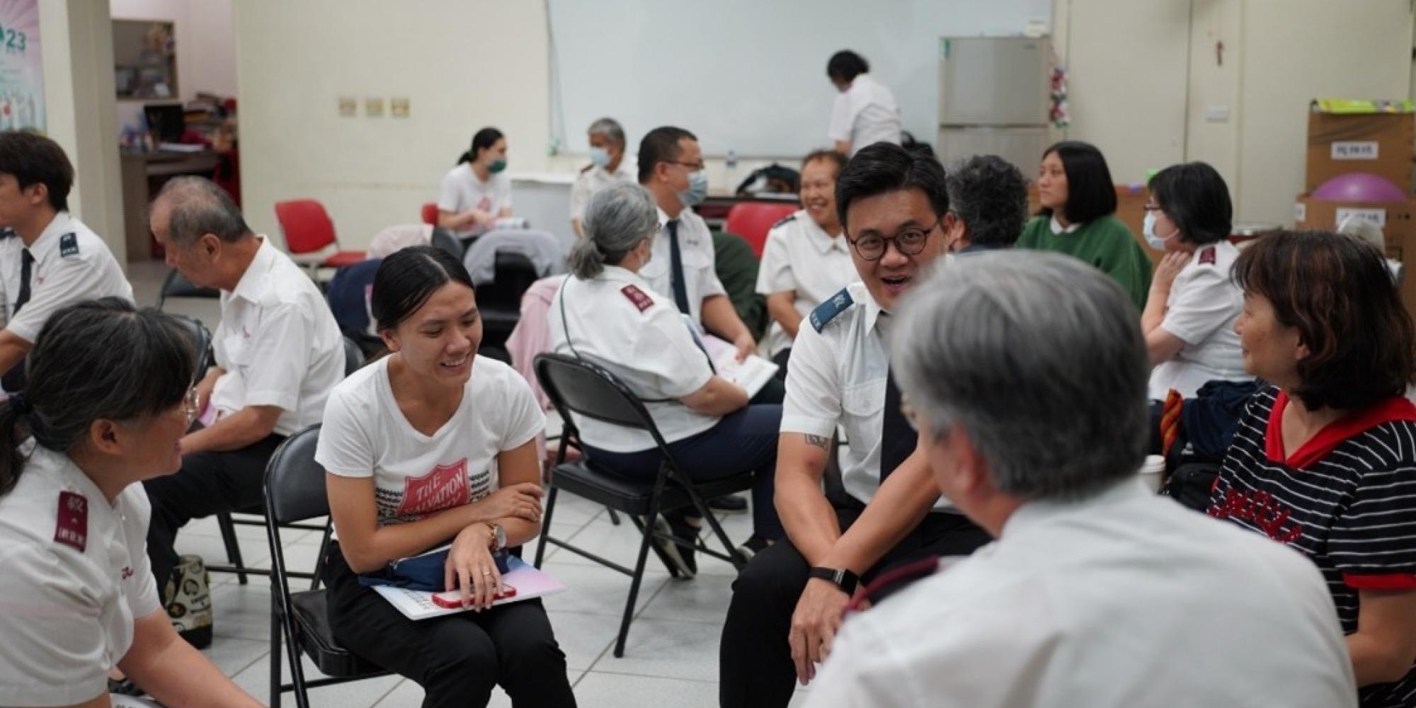 People in Salvation Army uniform talk in a group