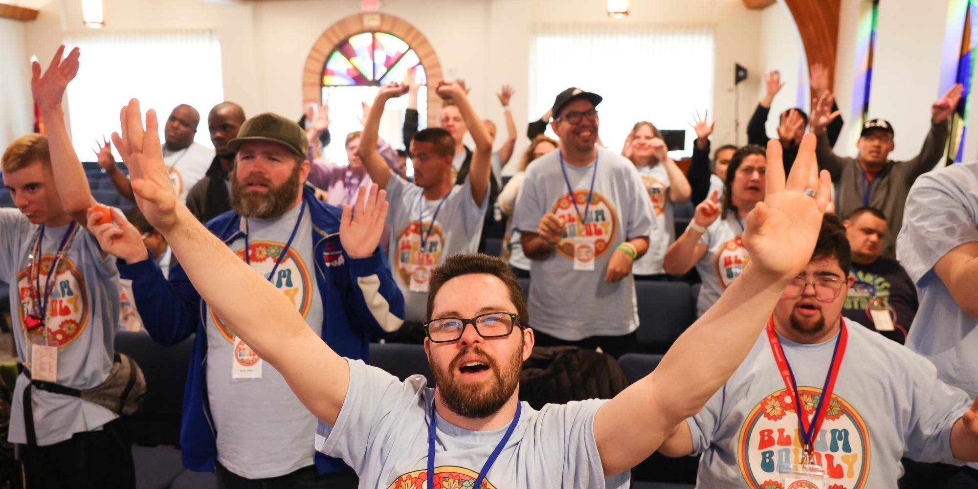 People raise their hands in worship