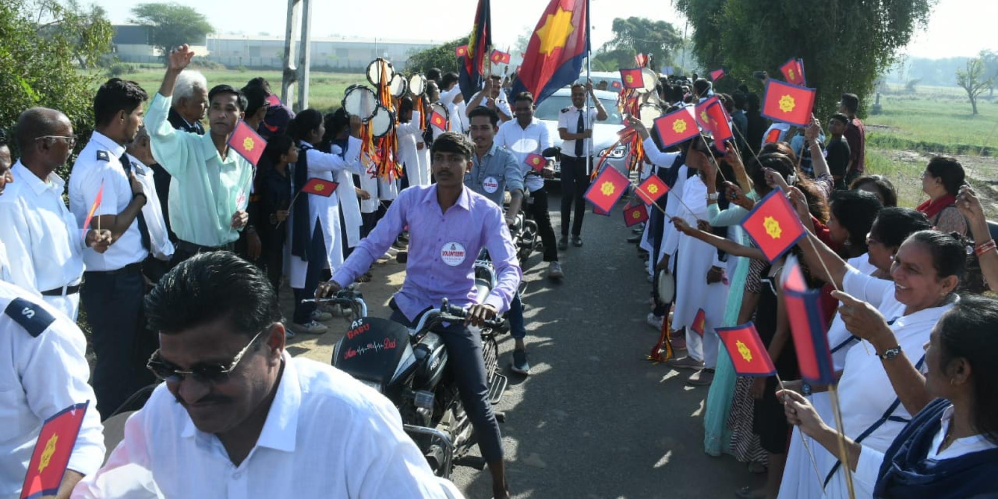 A crowd wave Salvation Army flags