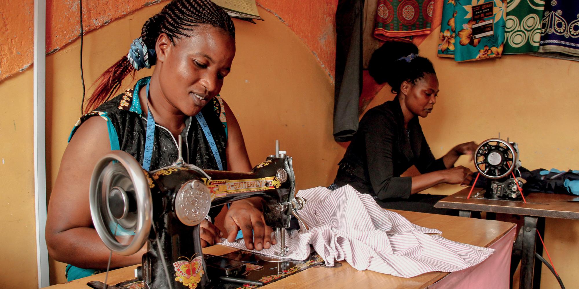 Two women work at sewing machines