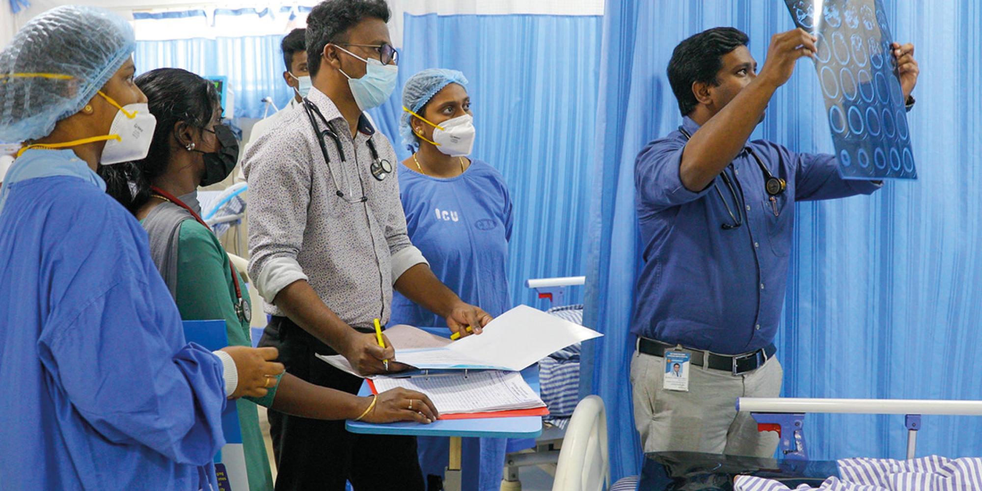 Doctors view test results at a Salvation Army hospital in India