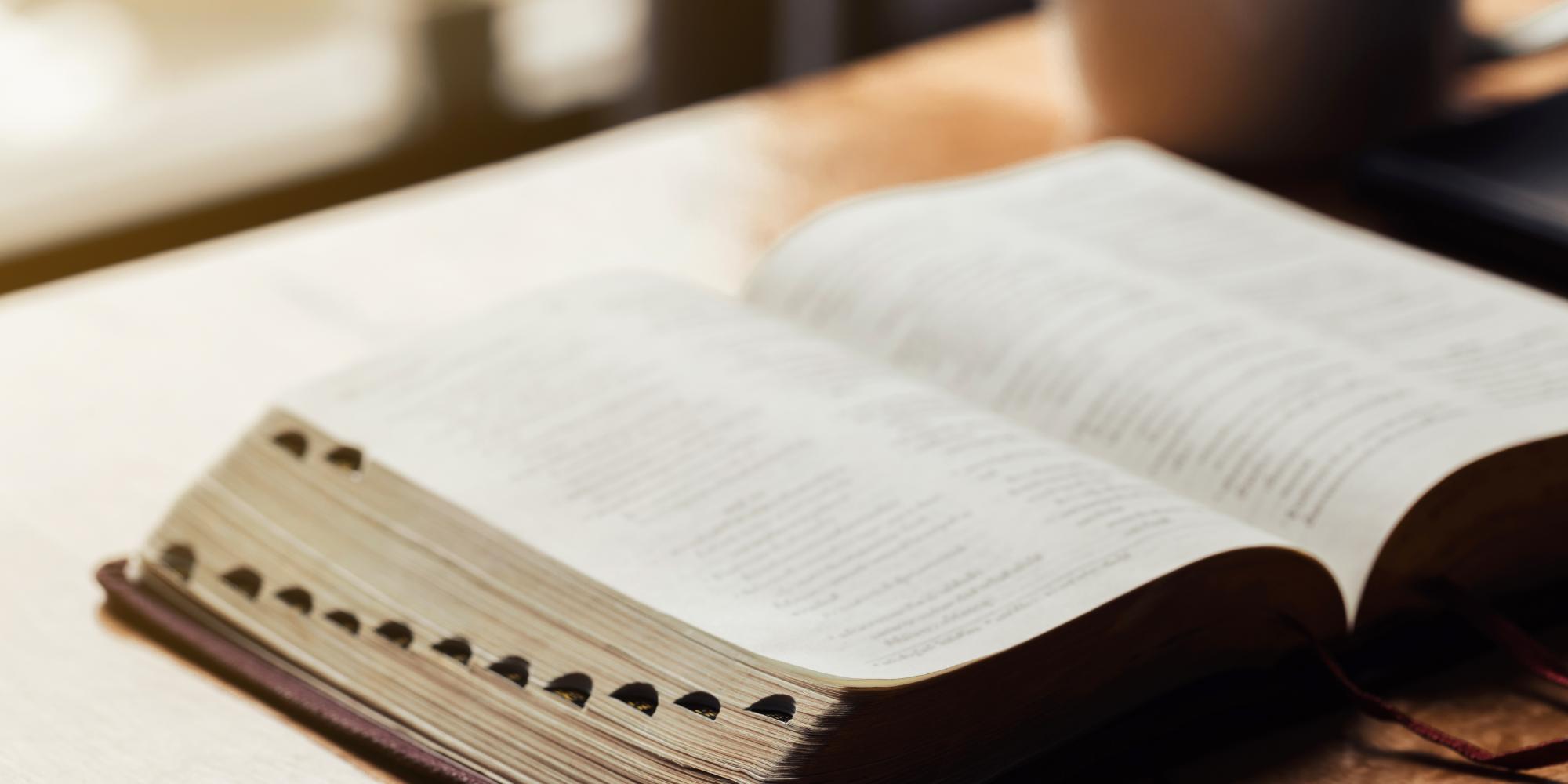 An open Bible sits on a table