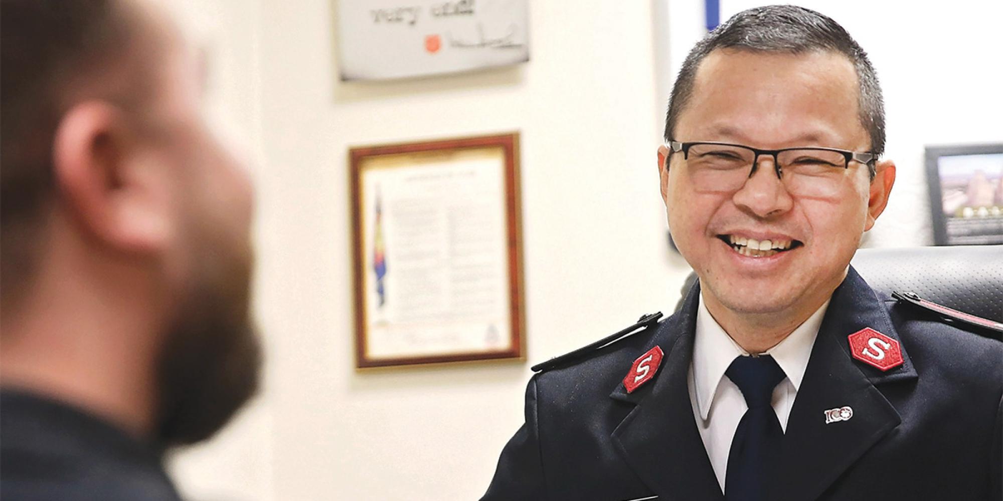 A Salvation Army officer in conversation with someone