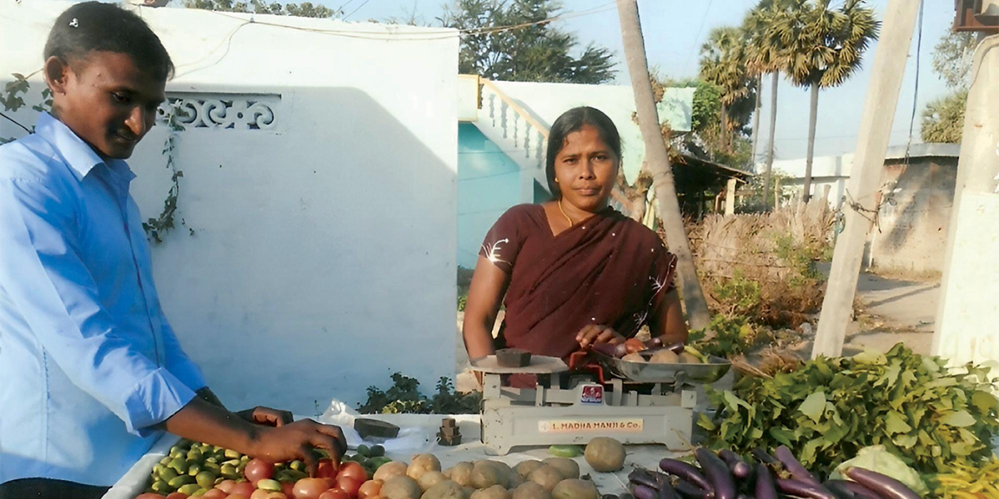 A woman runs a vegetable stall