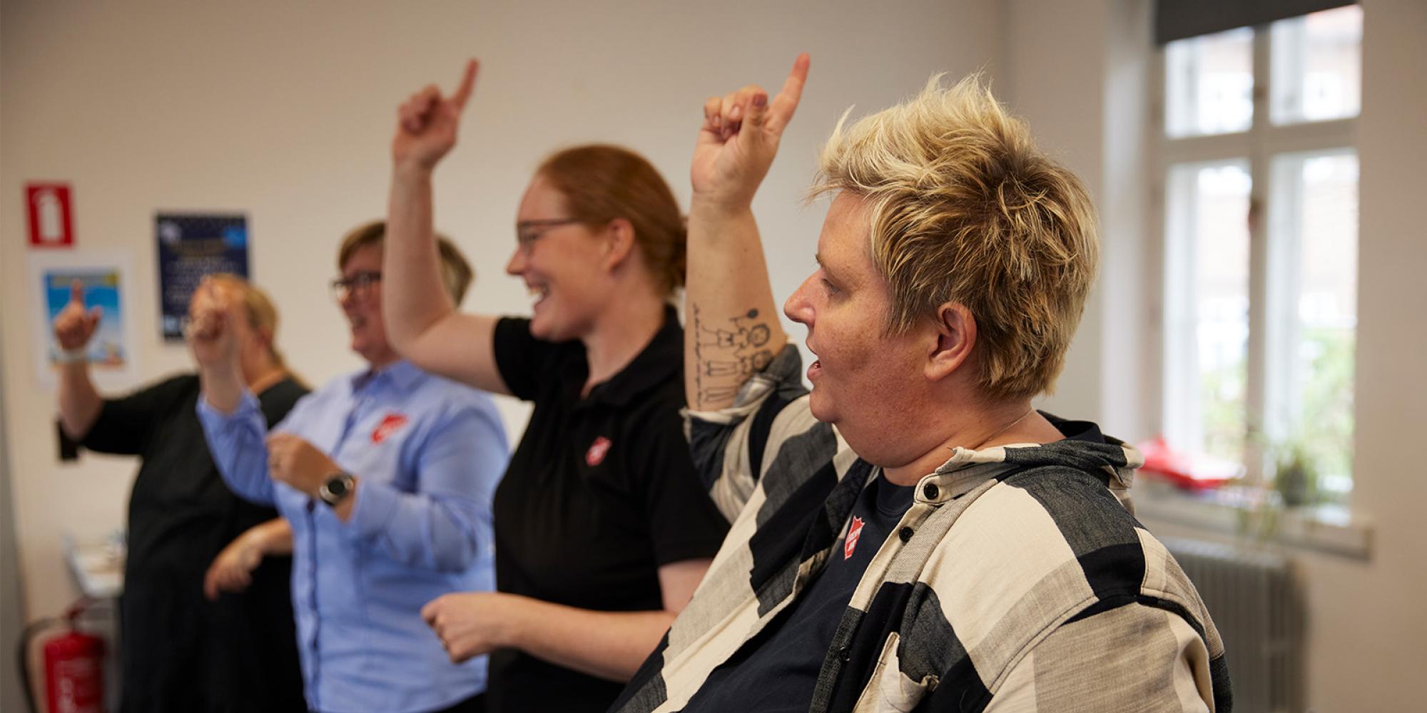A group raise their hands in worship