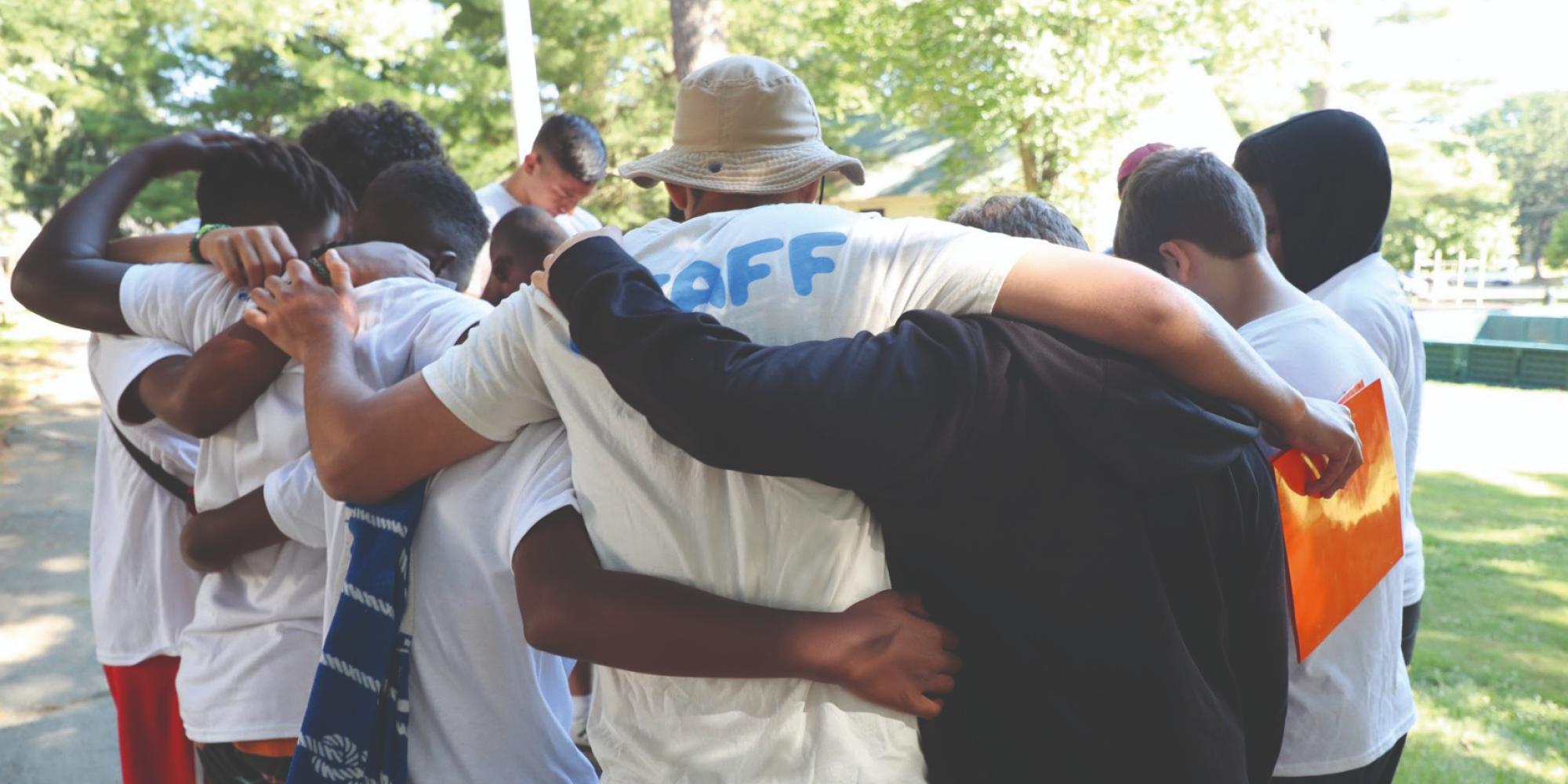 A group of young people with their arms around each other
