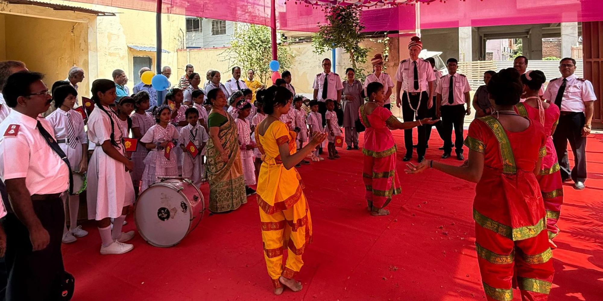 Commissioners Hill are welcomed by a crowd, music and dancers