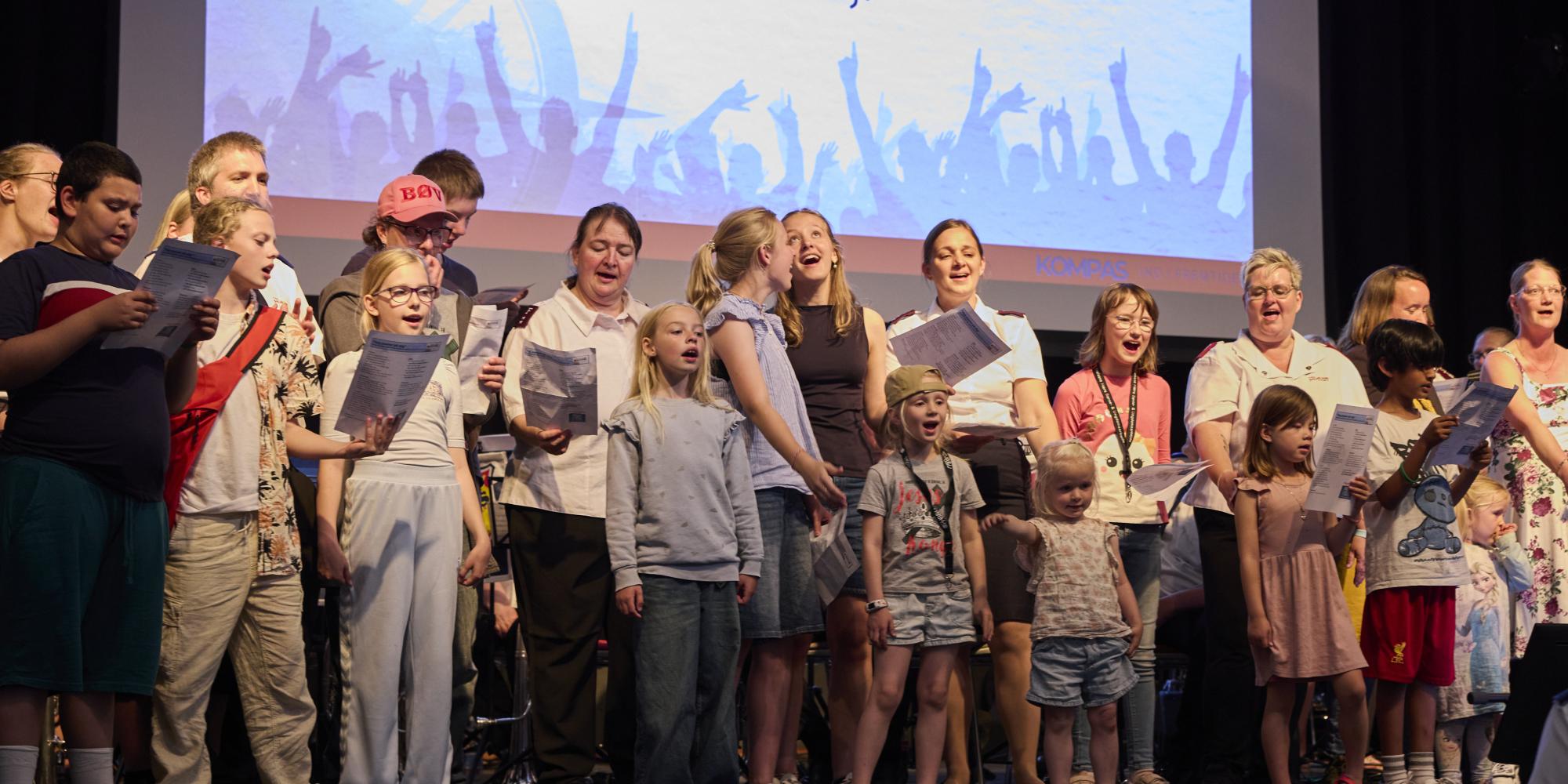 Adults and children sing in a family choir