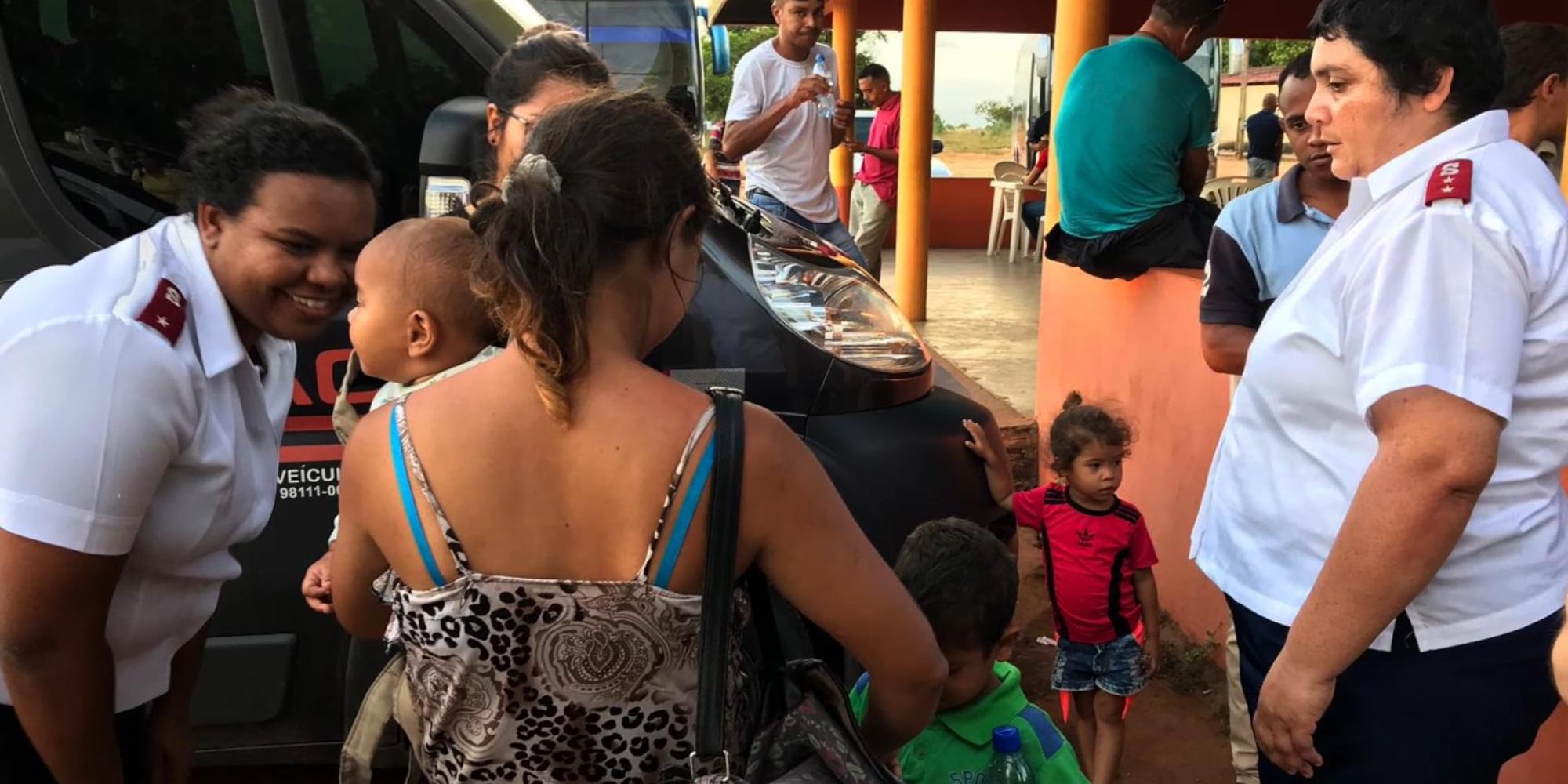Salvation Army officers speak to a family in Brazil