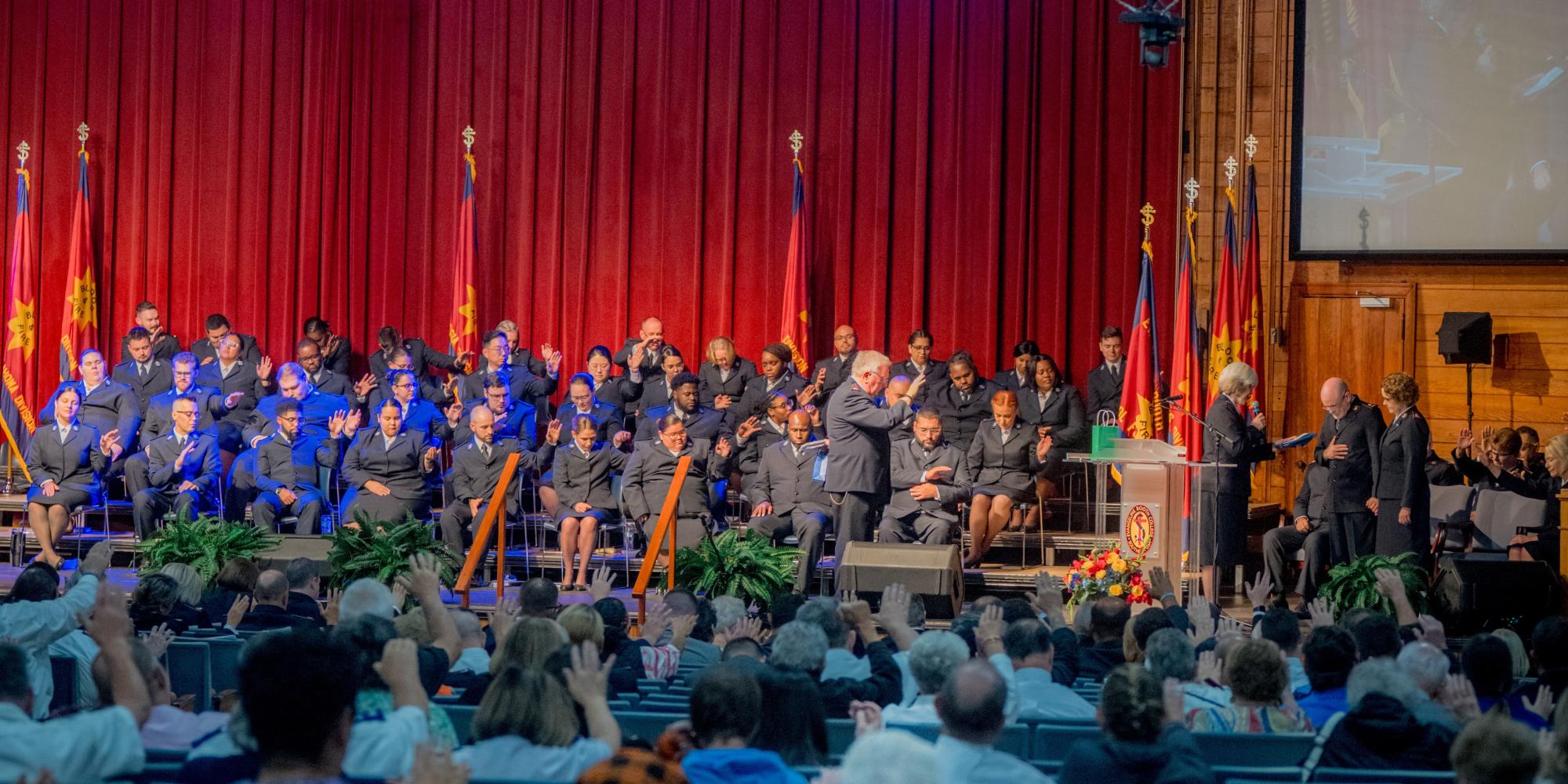 USA Southern Territorial Secretaries along with cadets and Bible Conference delegates, pray a blessing over the international leaders