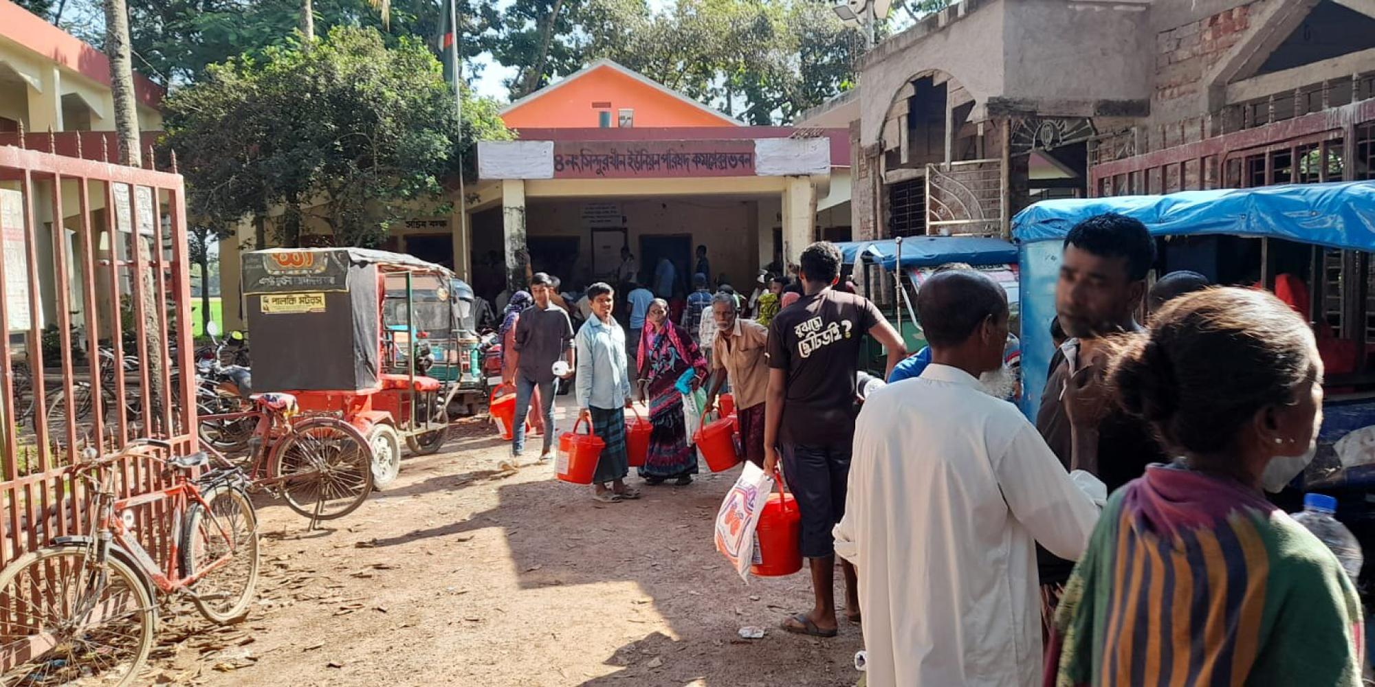 People queue for flood relief supplies