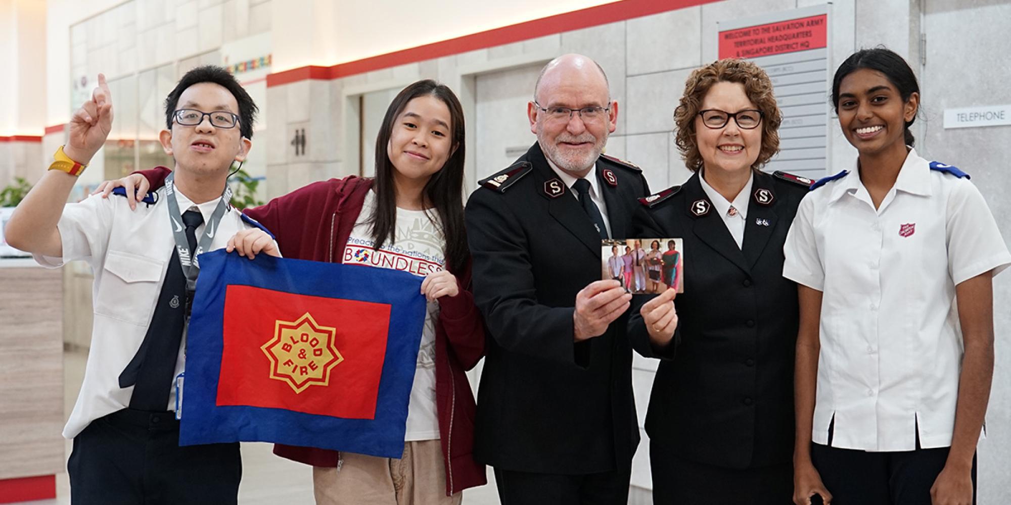The international leaders recreate a photograph with young people