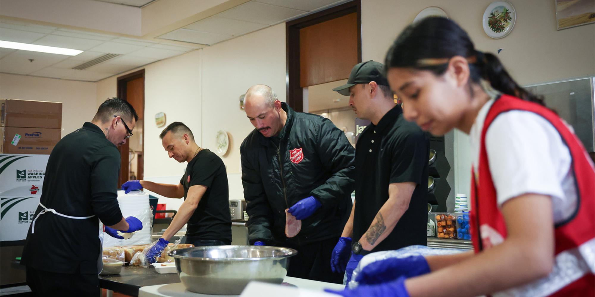 Salvation Army volunteers prepare sandwiches
