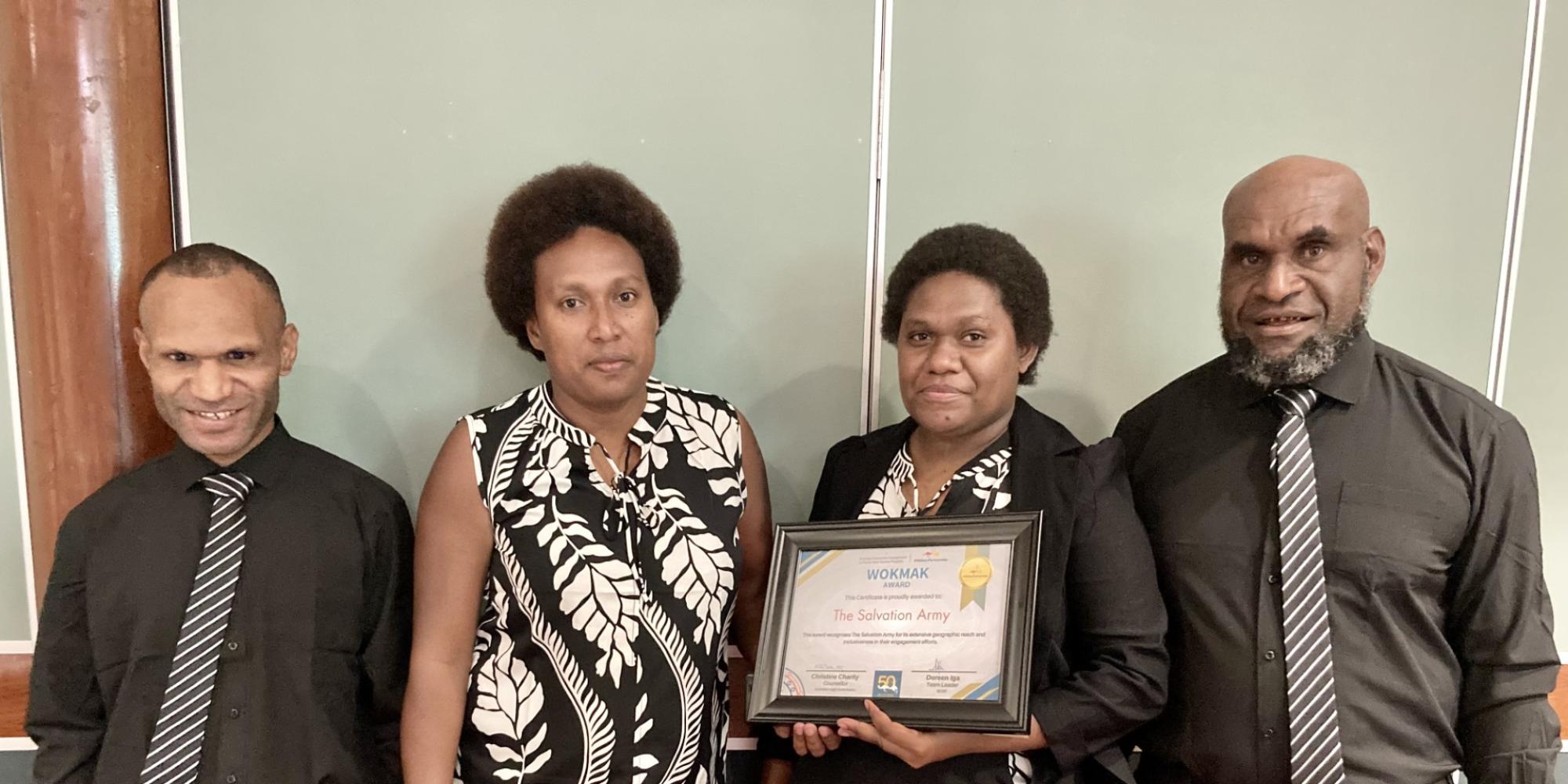 Church Partnership Program team members hold the award