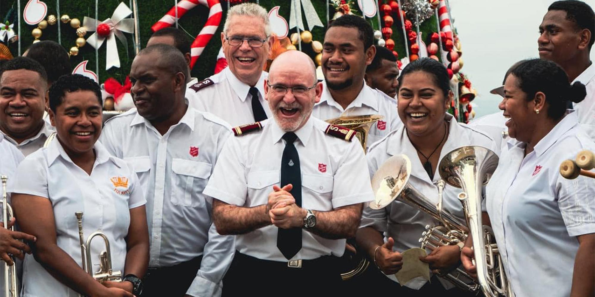 The General laughs with Salvation Army band members