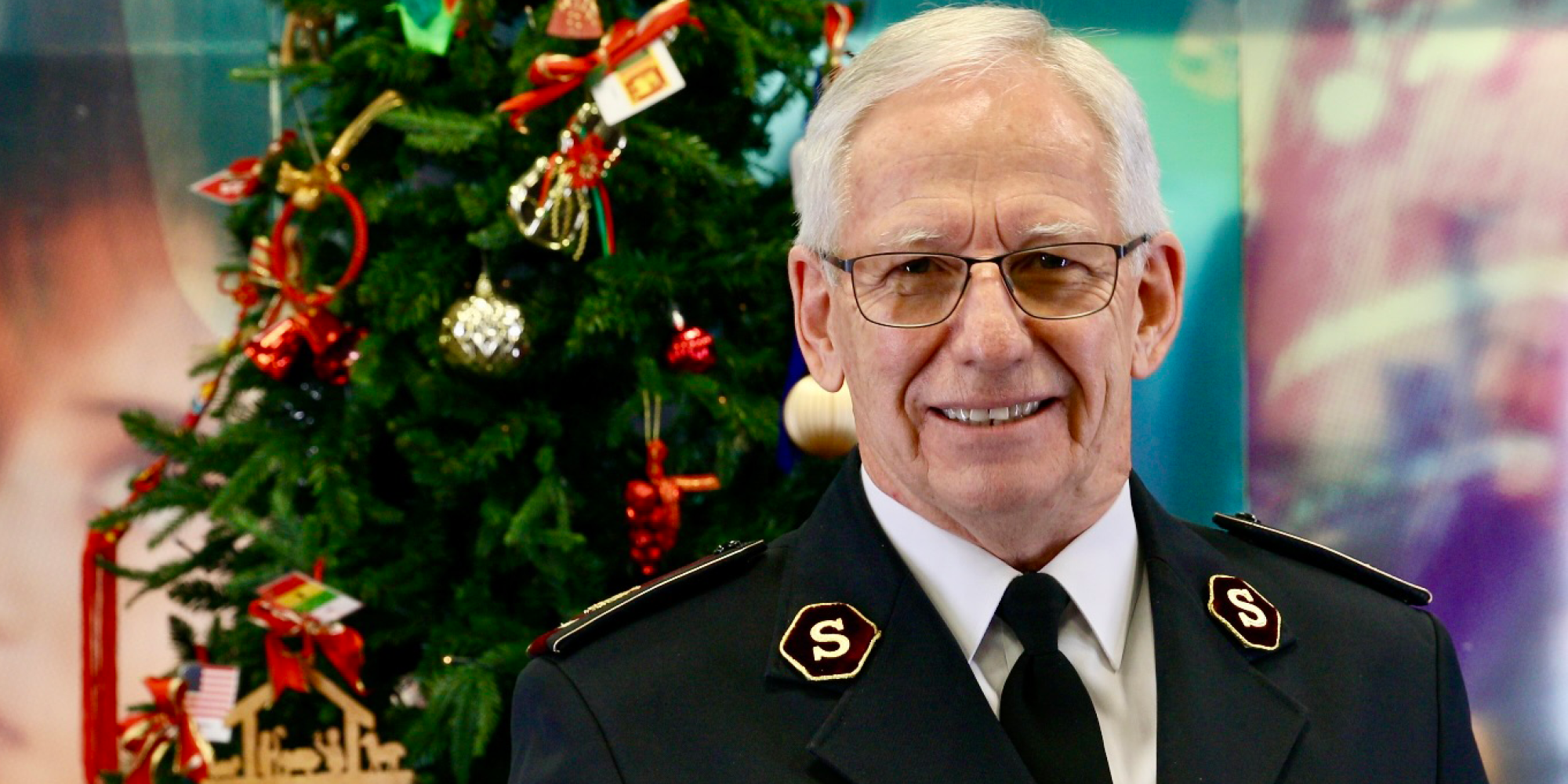 General Brian Peddle stands in front of a Christmas tree
