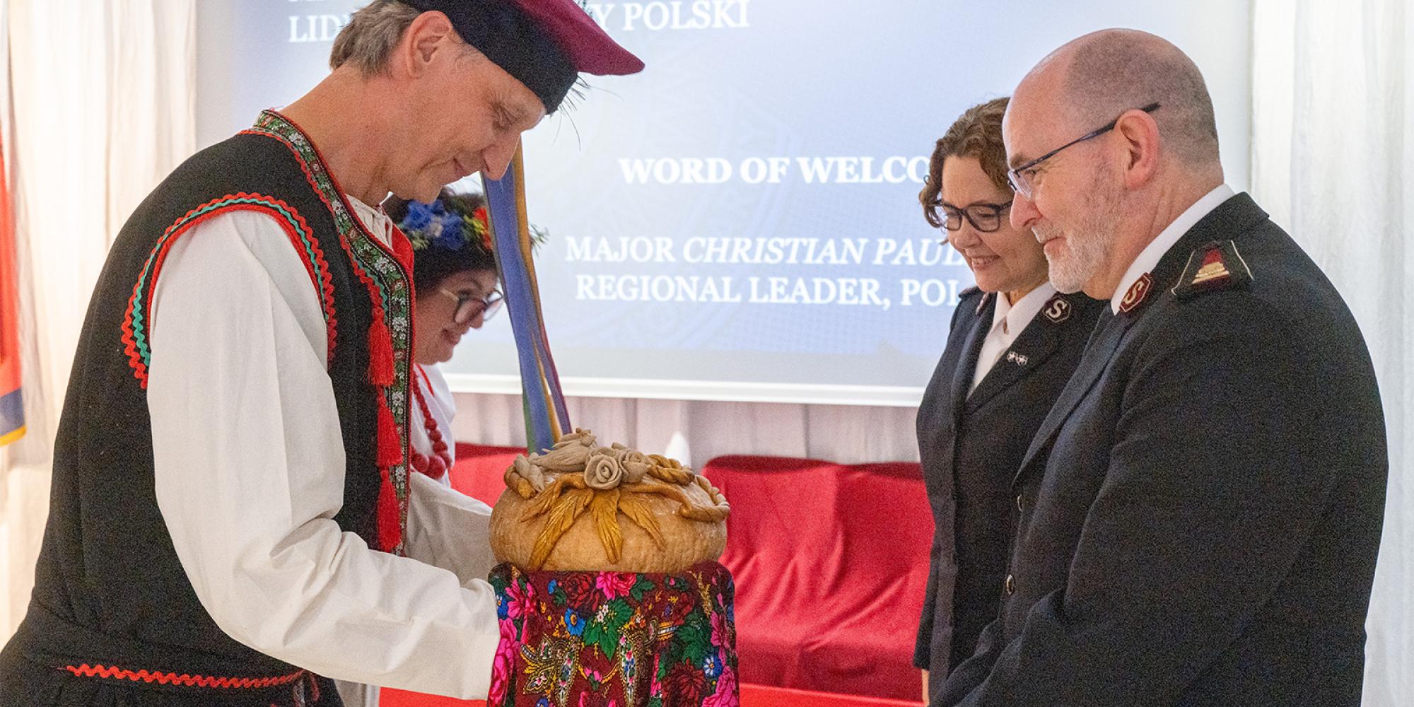 The international leaders are greeted with a traditional welcome gift of bread