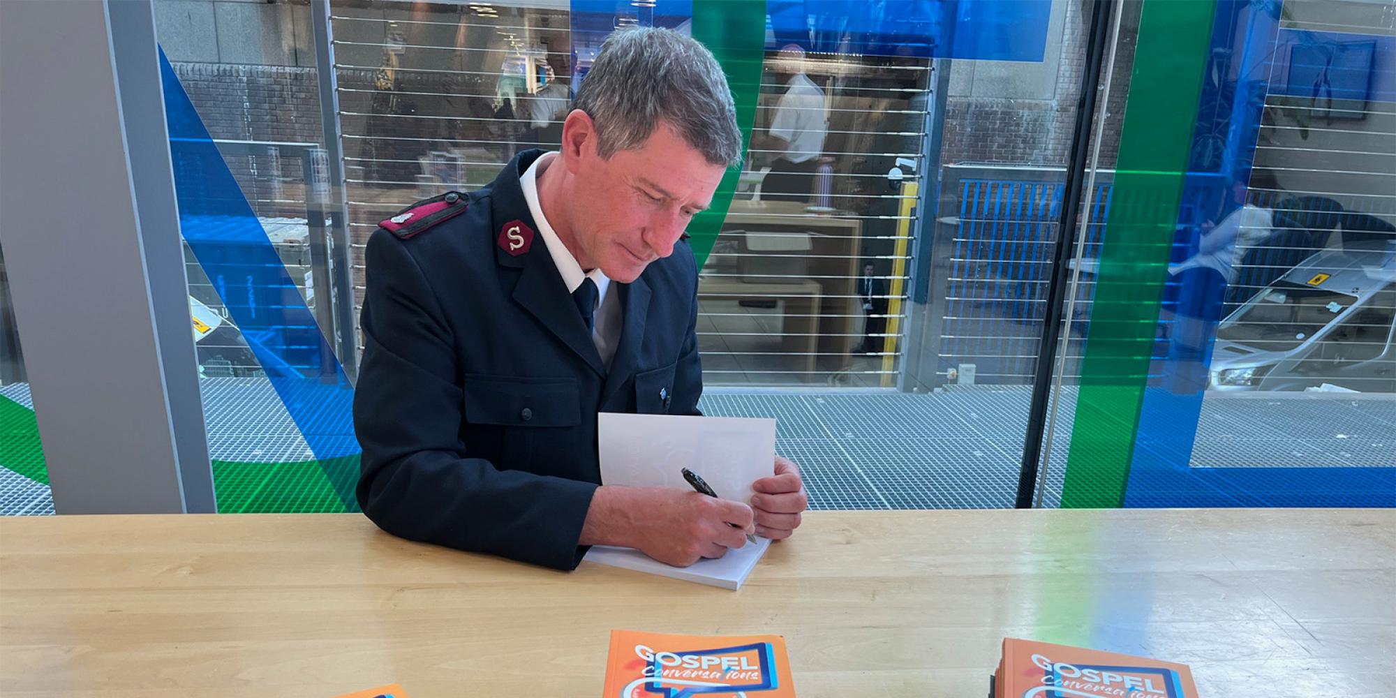 Major Phil Layton signs copies of Gospel Conversations