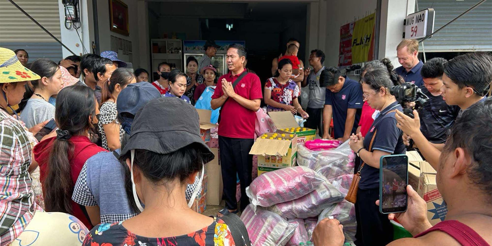 A Salvation Army team member prays over supplies