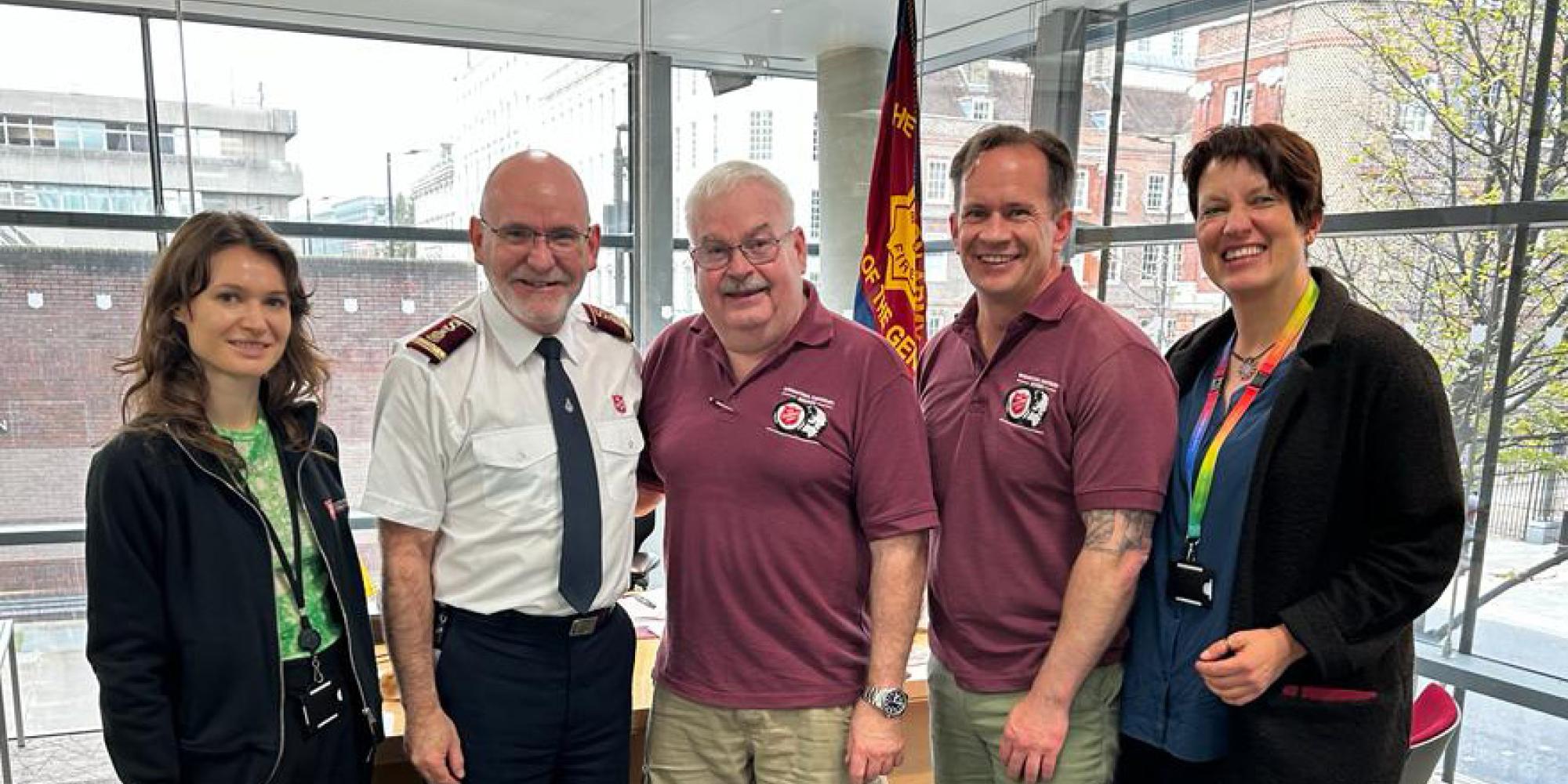 Major Brad Watson stands with General Lyndon Buckingham and members of the International Emergency Services team