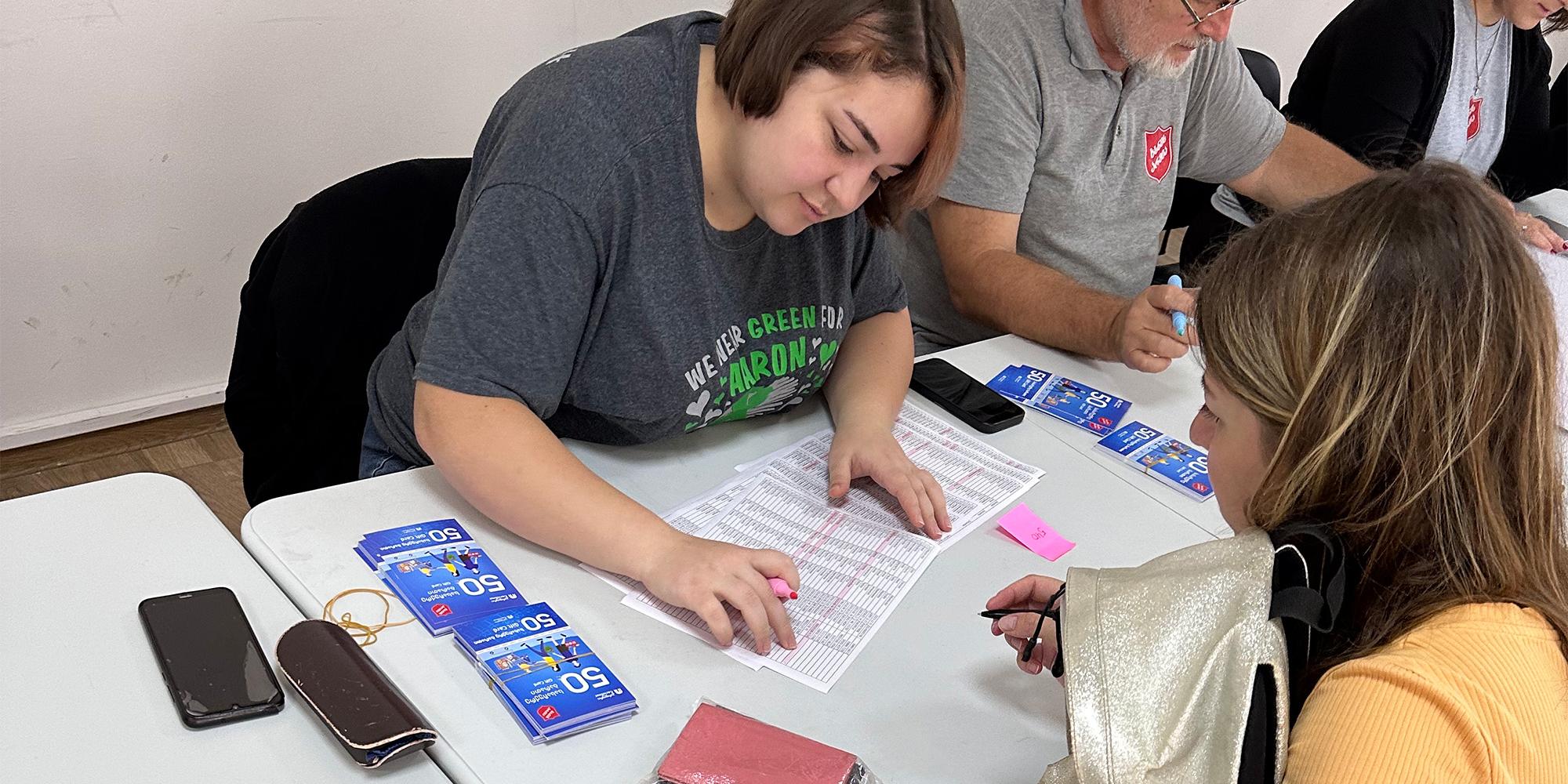 A Salvation Army team issue food vouchers for refugees